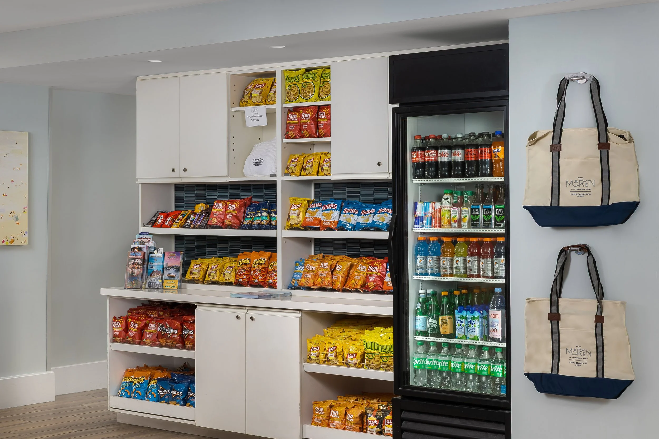 Snacks and beverages in a hotel convenience area, including chips, soft drinks, and bottled water.