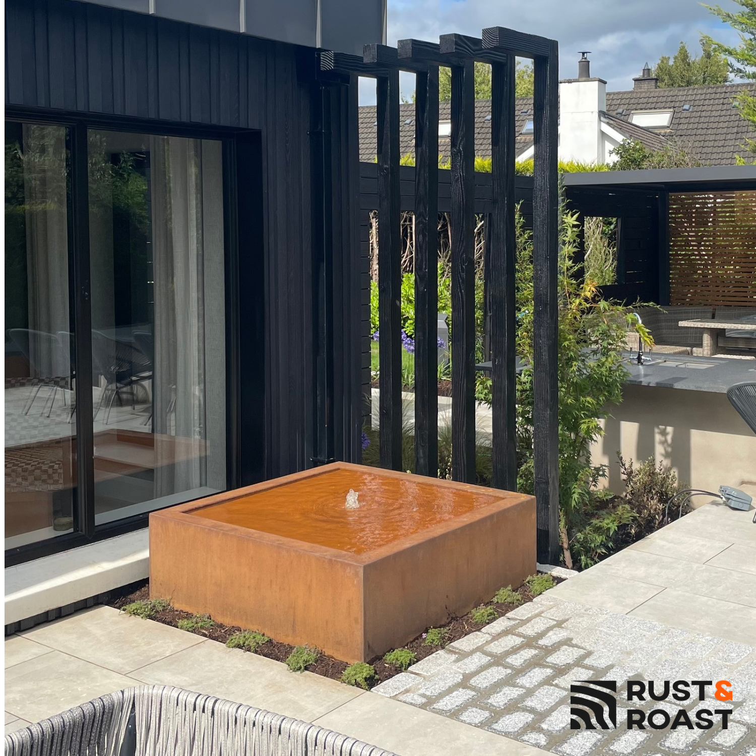 ontemporary corten steel garden fountain outside modern home