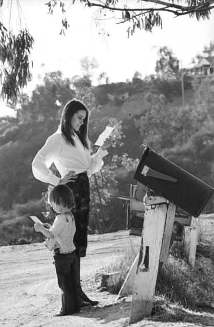 Barbara Hershey & son reading their mail