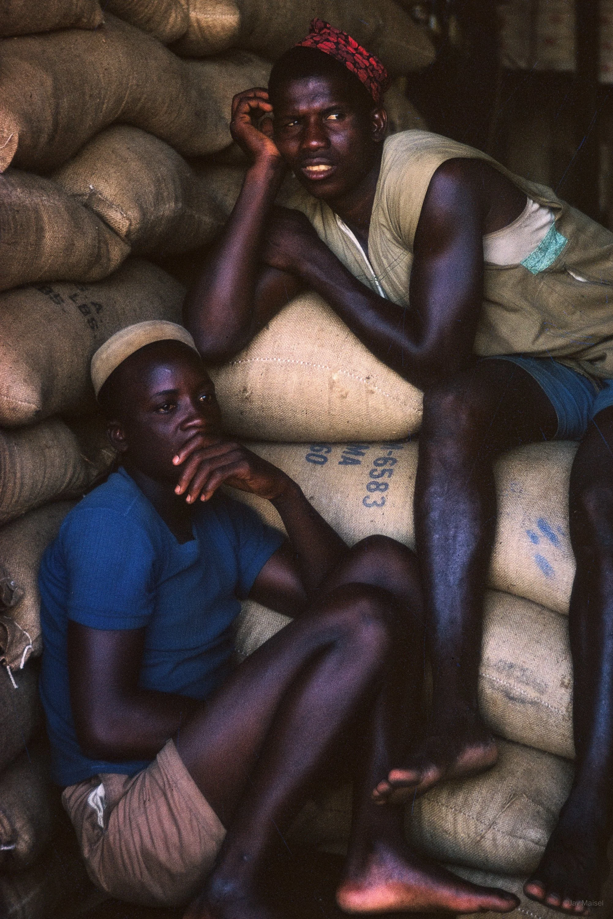 Two Men on Coffee Bags, Ghana 1966 © Jay Maisel