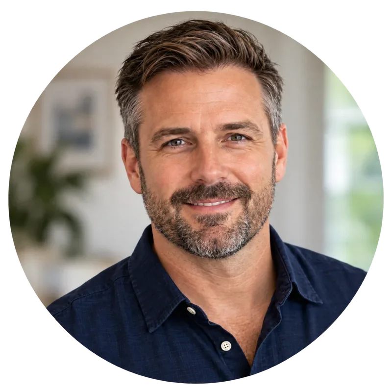 Portrait of a smiling man with short brown hair and a beard