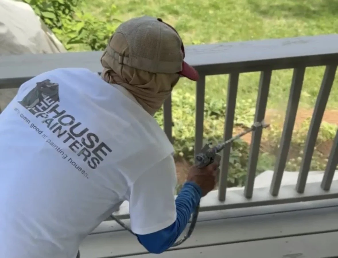 The House Painters crew spray-painting a deck railing in Green Hills, Nashville TN