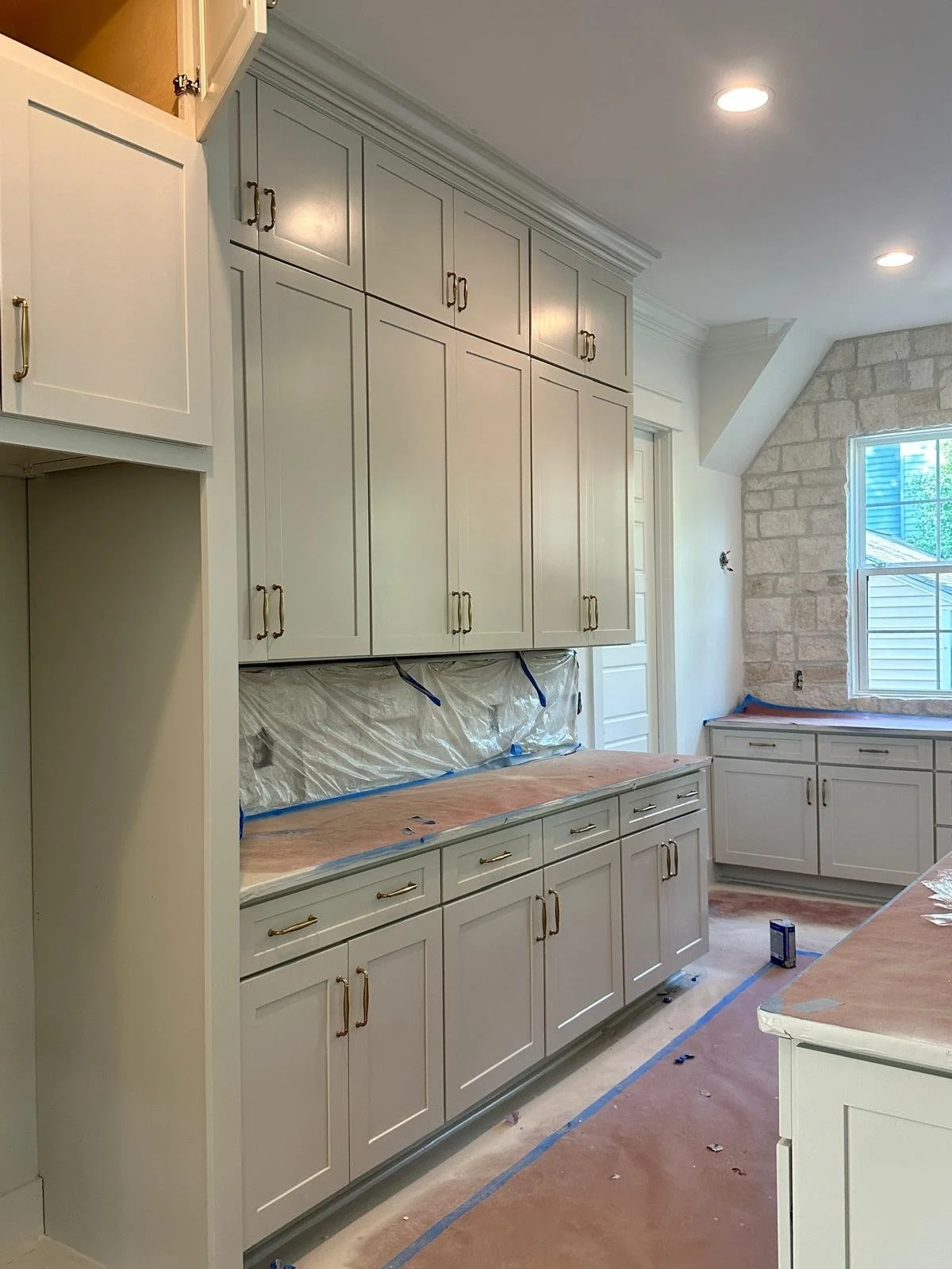 Light gray painted kitchen cabinets with built-in storage by The House Painters in Nashville TN