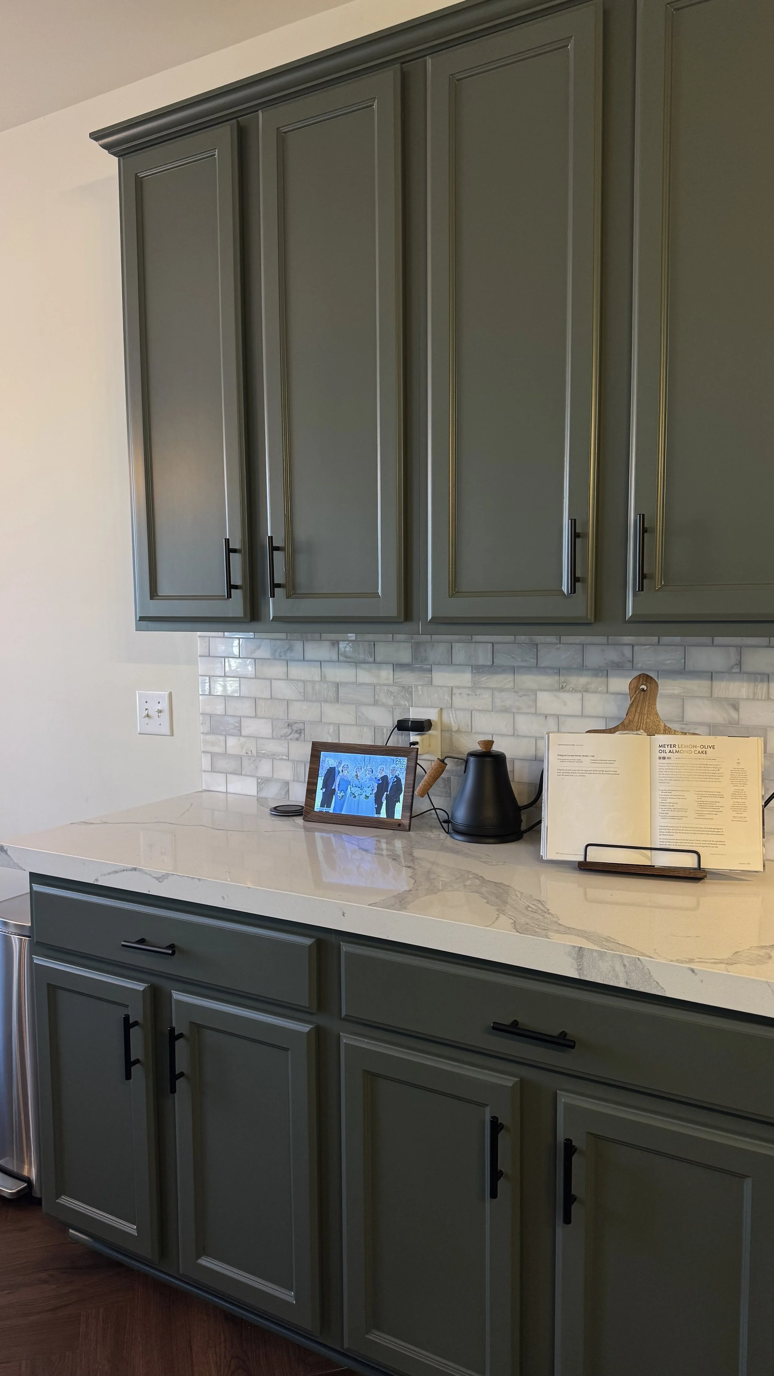 Sage green painted kitchen cabinets with white quartz counter, Nashville cabinet painting