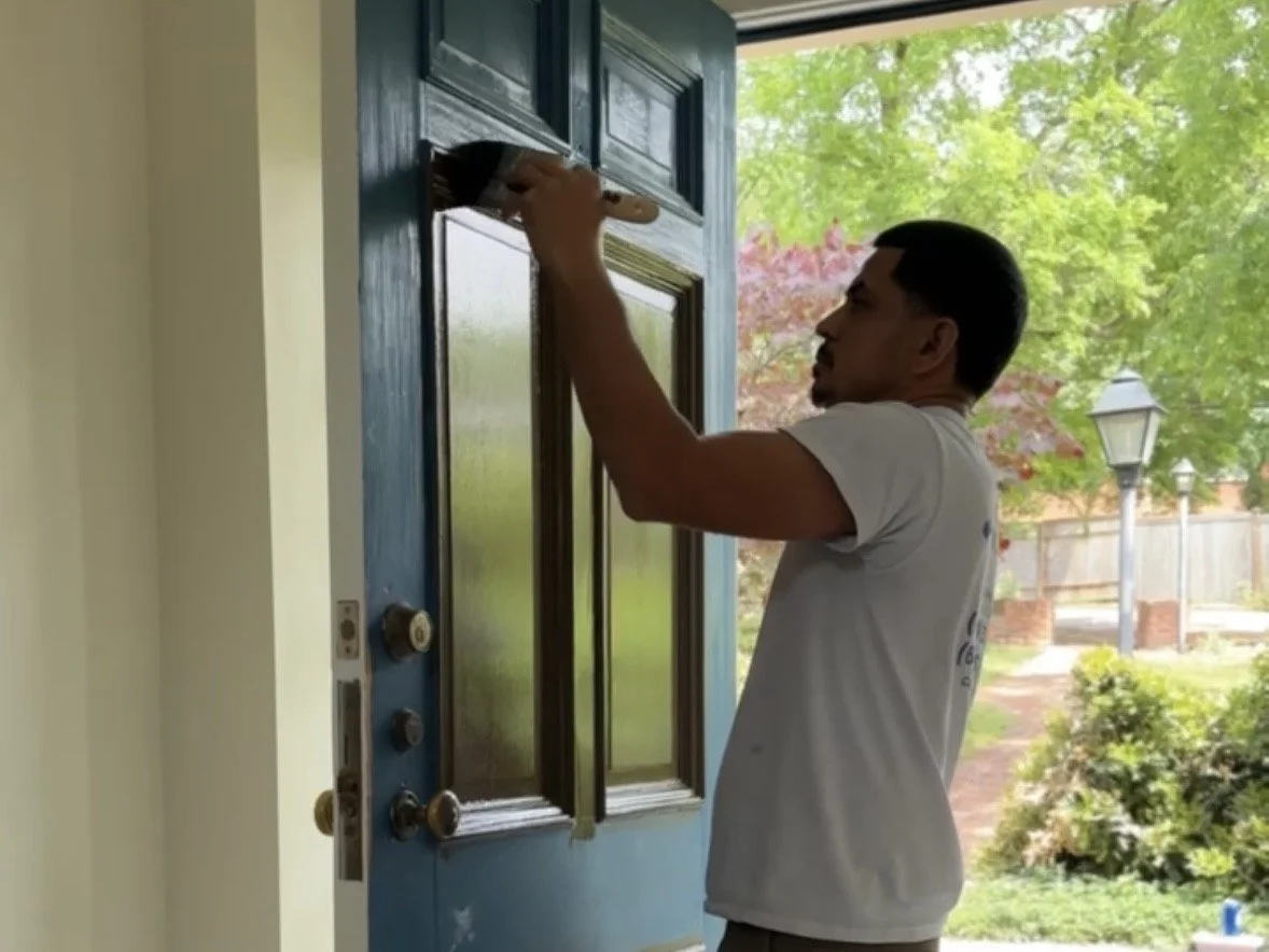 The House Painters crew refinishing a front door on a Green Hills, Nashville home
