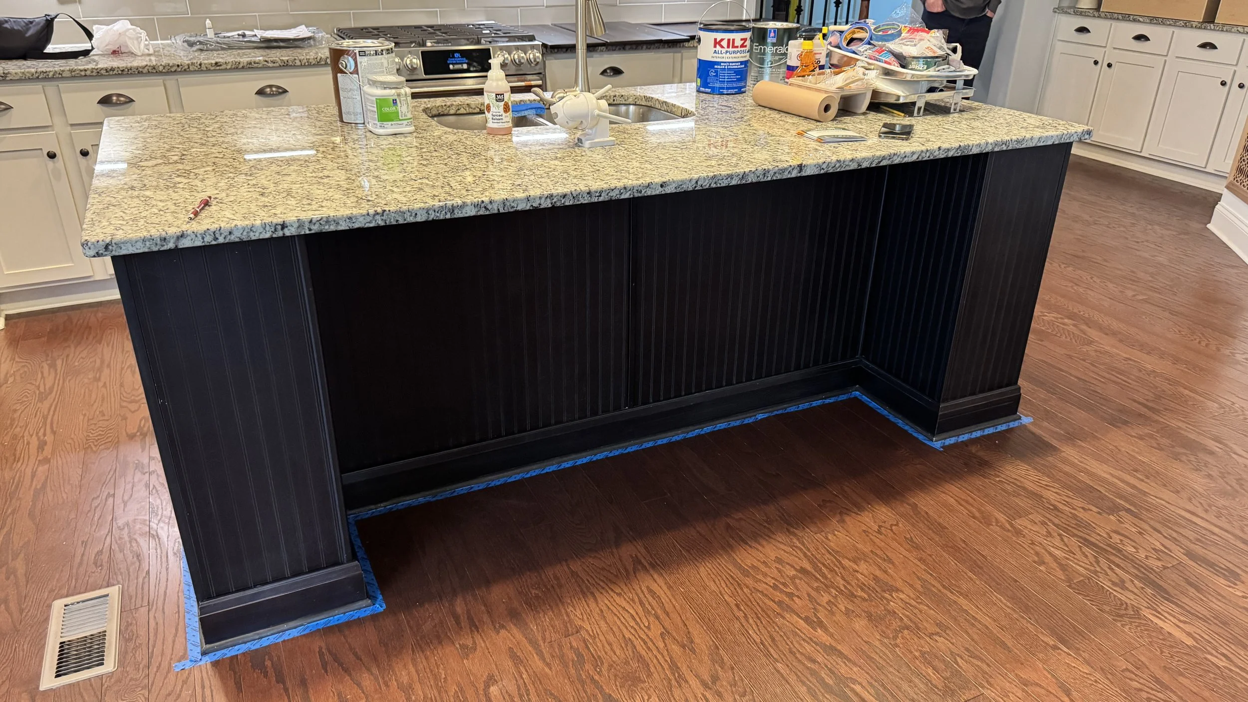 Black painted kitchen island with granite countertop, cabinet painting Nashville