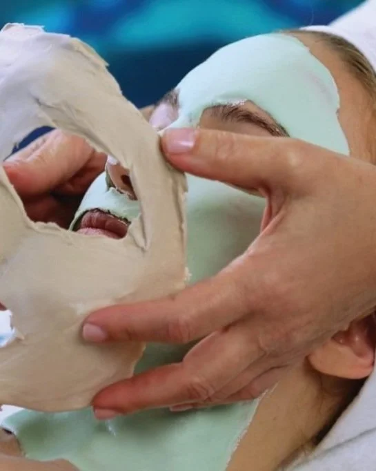 Clay mask being removed from the fountain of youth facial.