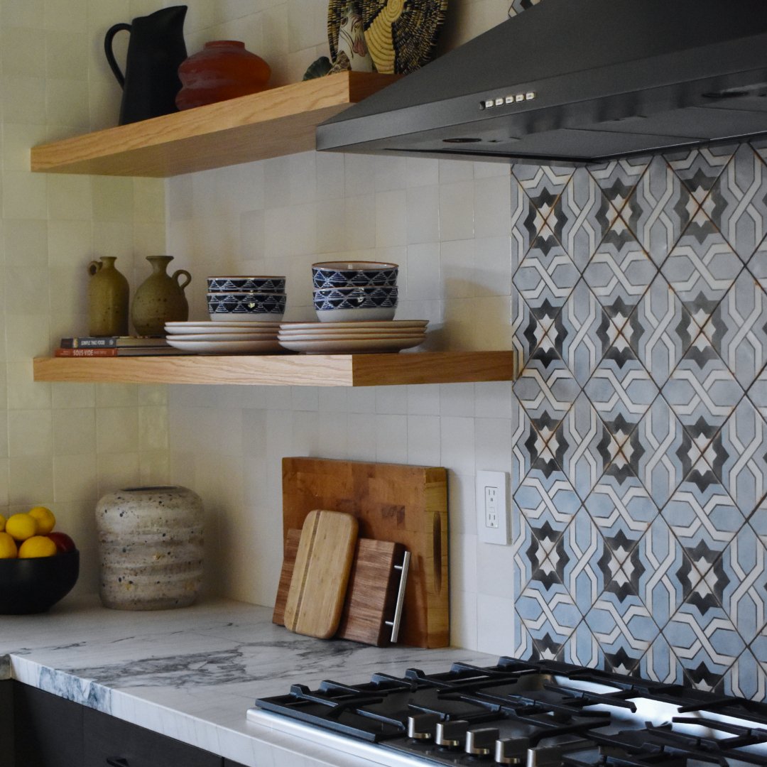 Modern meets Spanish charm! The floating shelves, bold tile, and sleek range hood give Casita Via Serra&rsquo;s kitchen a fresh new vibe. What do you think of the transformation?⁠
⁠
&mdash;&mdash;⁠
⁠
#baworthing #design #architecture #style #decor #c