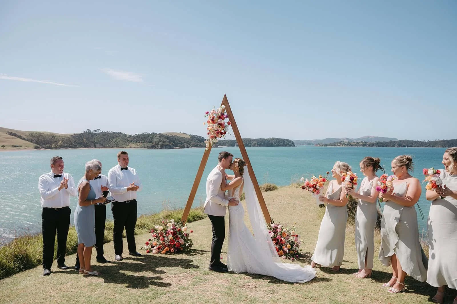Bride and Groom Kissing at Coastal Wedding Ceremony