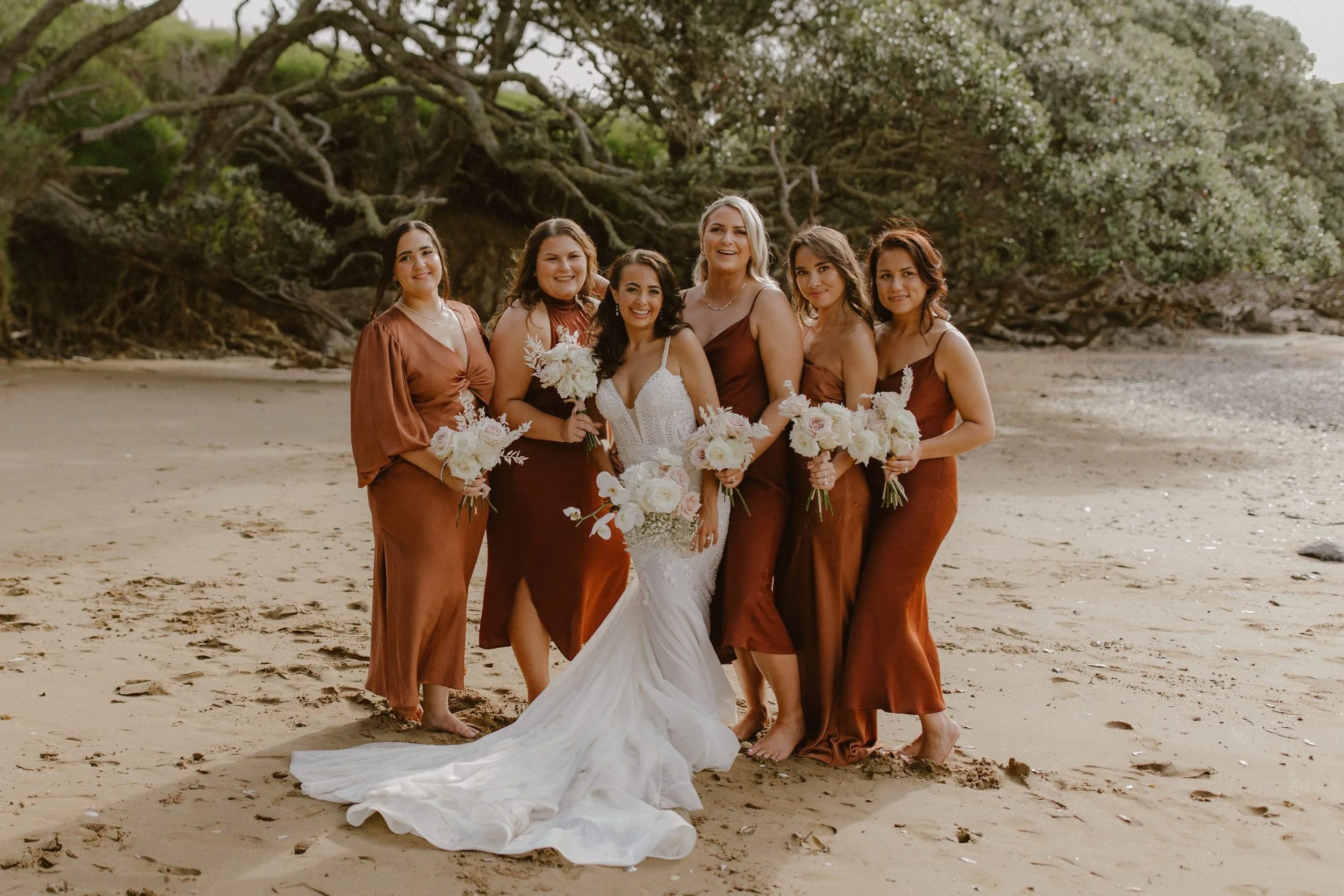 Bride and Bridesmaids Posing on Beach