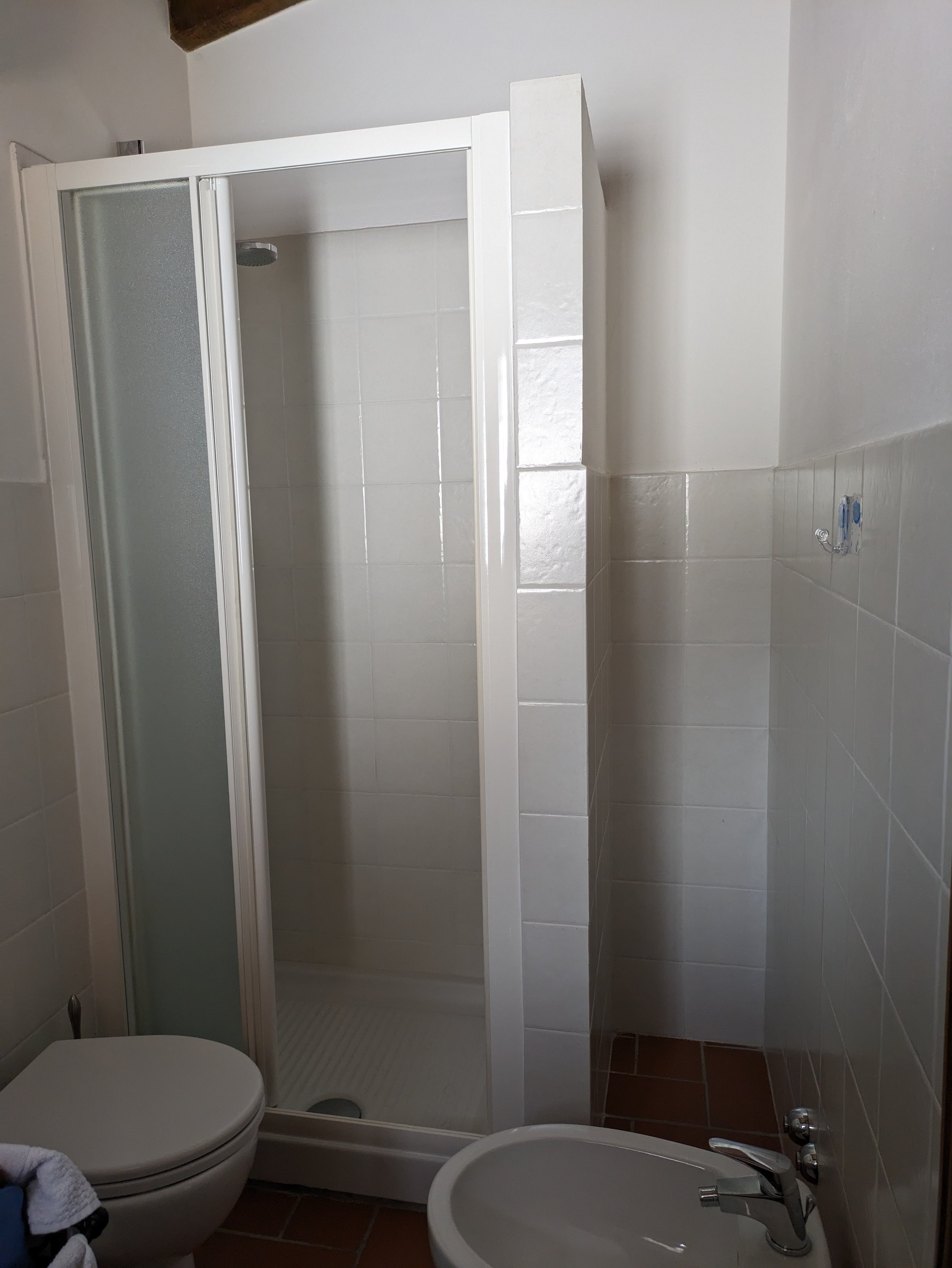 The upstairs bathroom has a bidet in addition to everything in the downstairs bathroom (shower, sink and toilet- with overhead tank!)