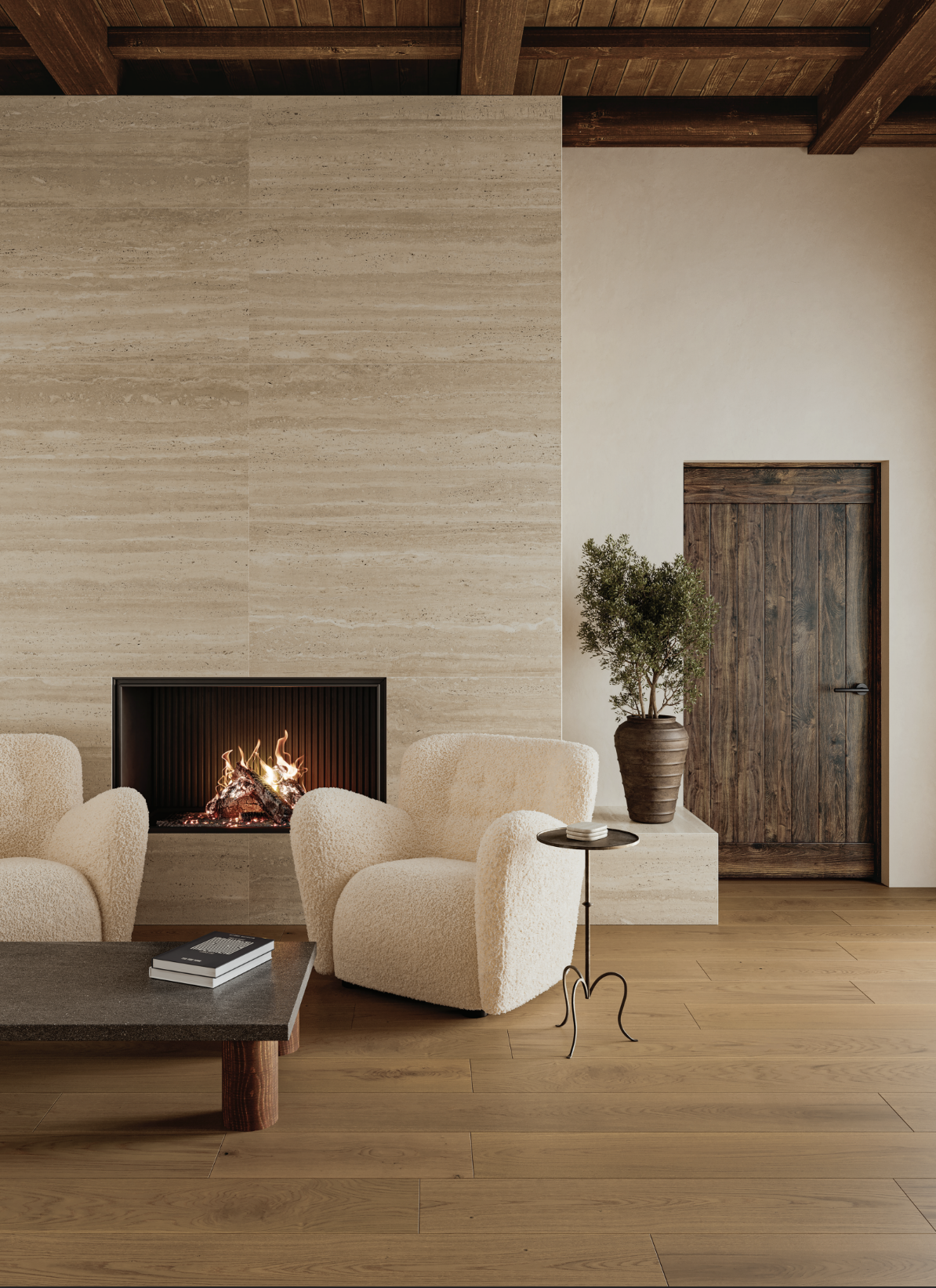 Living room with a fireplace, cream upholstered armchairs, wooden floor and door, a potted plant, and a small side table.
