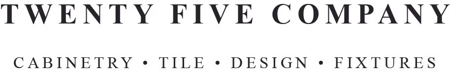 Close-up of a sign reading 'Twenty Five Company' with the words 'Cabinetry', 'Tile', 'Design', and 'Fixtures' underneath.