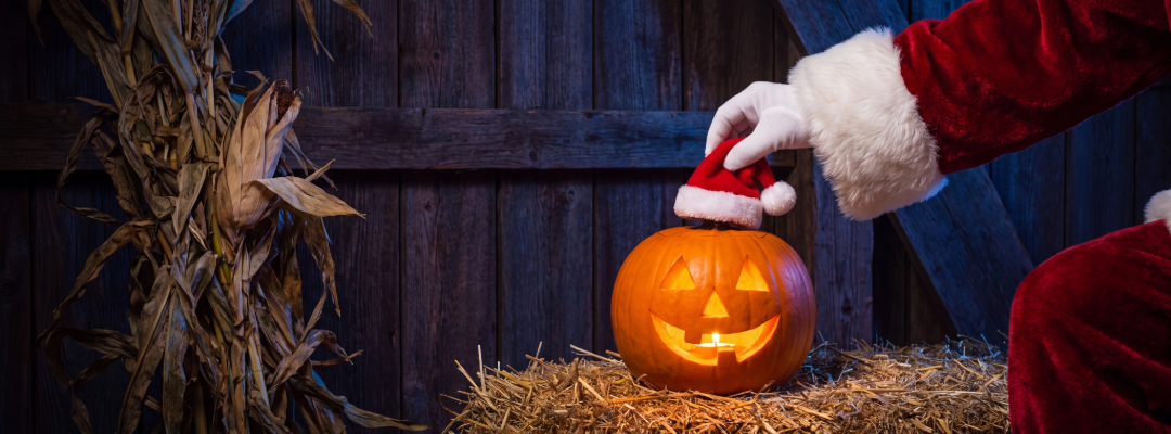 Santa Claus placing a Santa hat on a jack-o'-lantern to illustrate holiday spending tips for future homebuyers