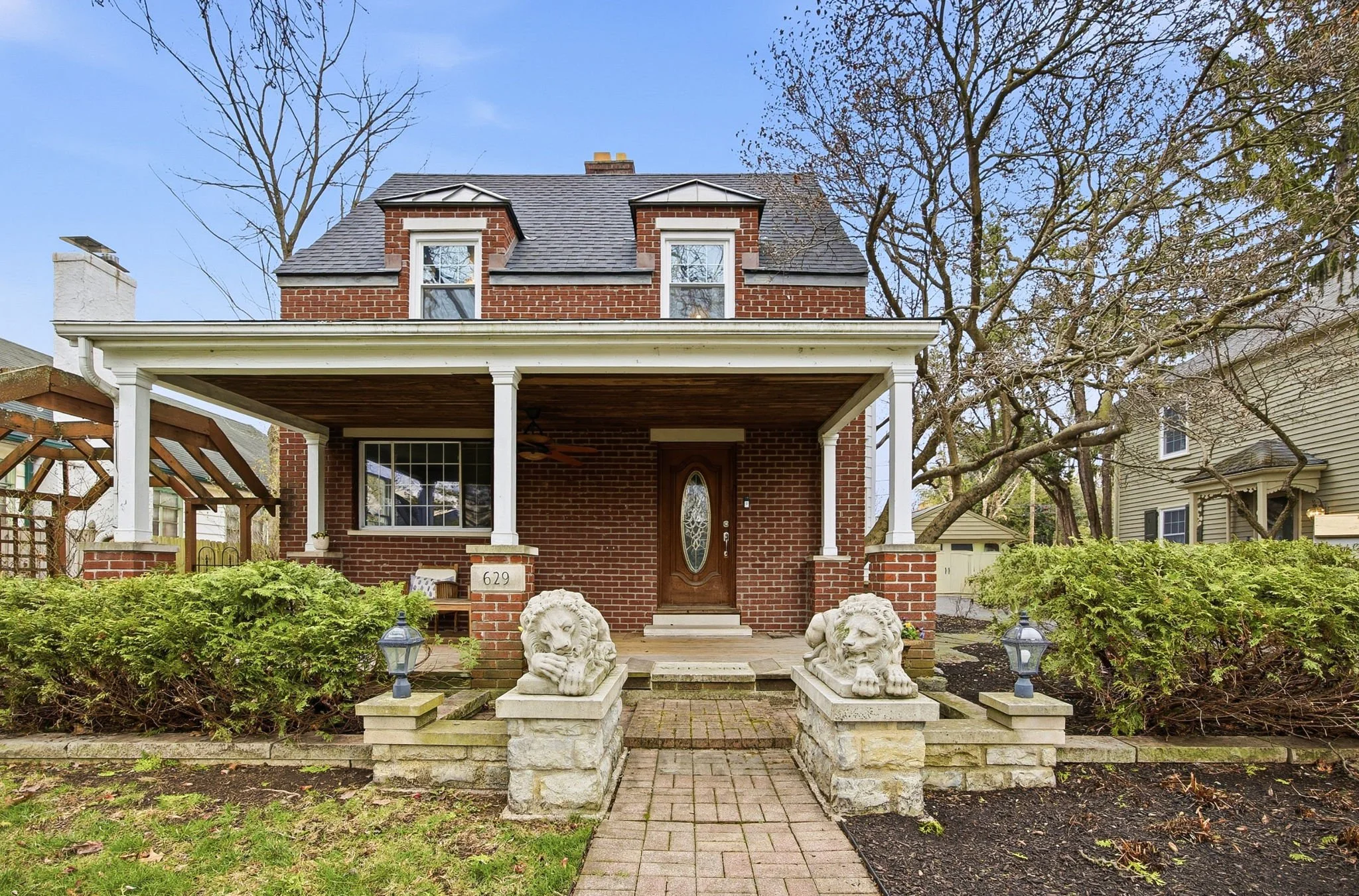 A pair of whimsical lion statues created a memorable, nostalgic, playful feeling the minute buyers approached this historic home just outside Bexley.