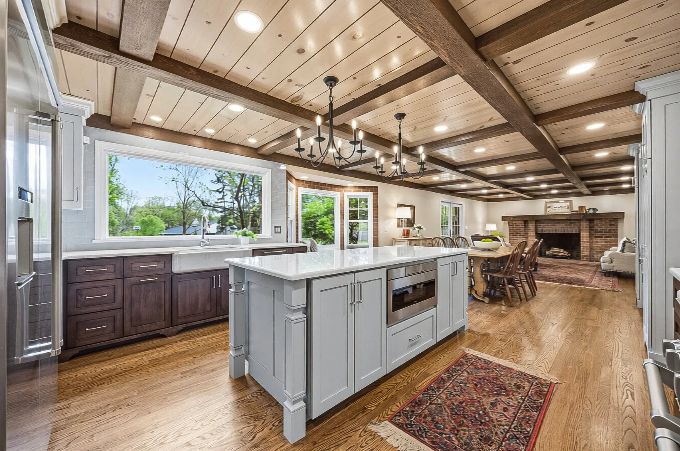 Every detail in this gorgeous renovated kitchen - from the custom ceiling and beams to the brick accents framing the view of the one-of-a-kind yard, created a WOW factor in this Upper Arlington home.
