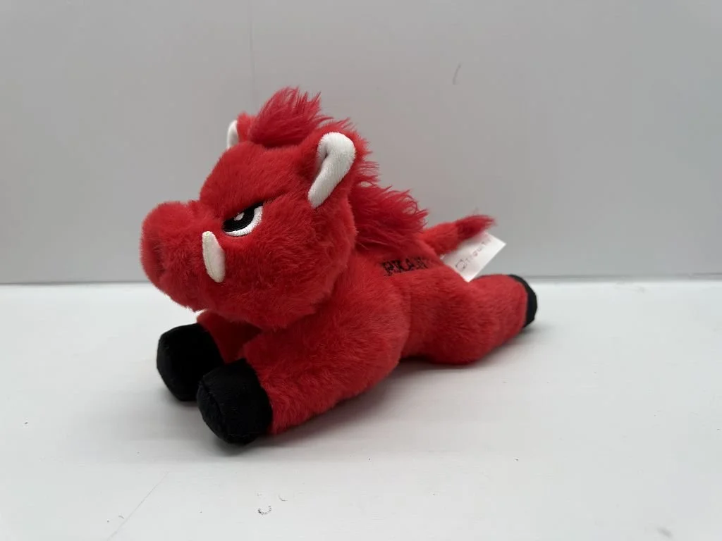 Plush reindeer toy with antlers, a brown mane, and limbs, sitting on a white background.