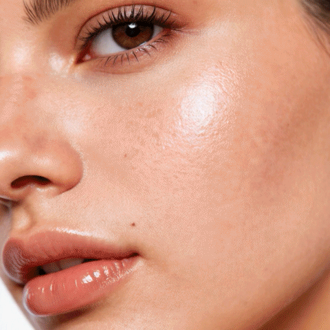 Skincare commercial for Rhode Glazing Milk. Various close-ups of a young woman's face showing her cheeks, nose, and lips with clear moisturized skin.