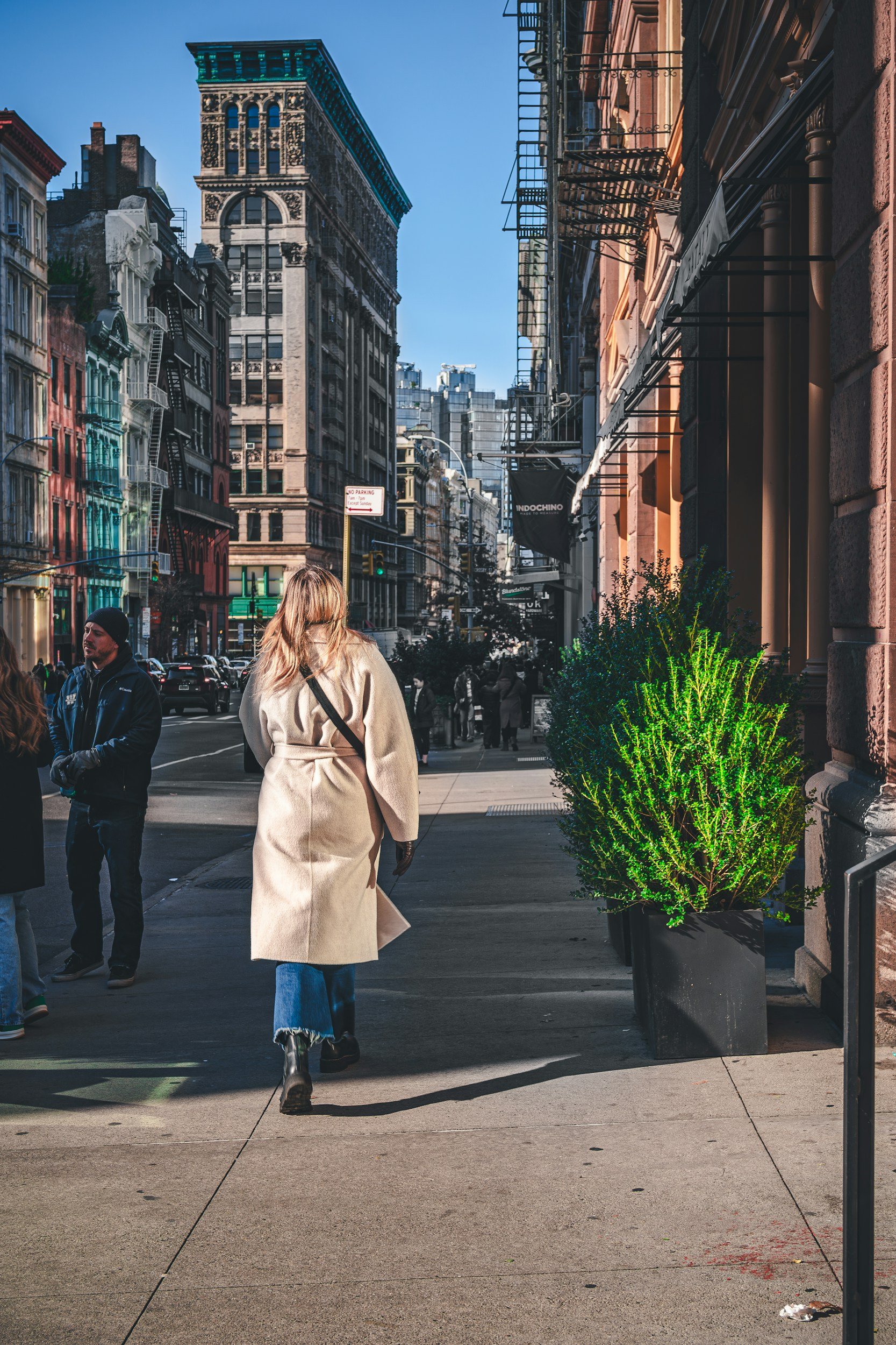 People walking along a Manhattan sidewalk in the morning.