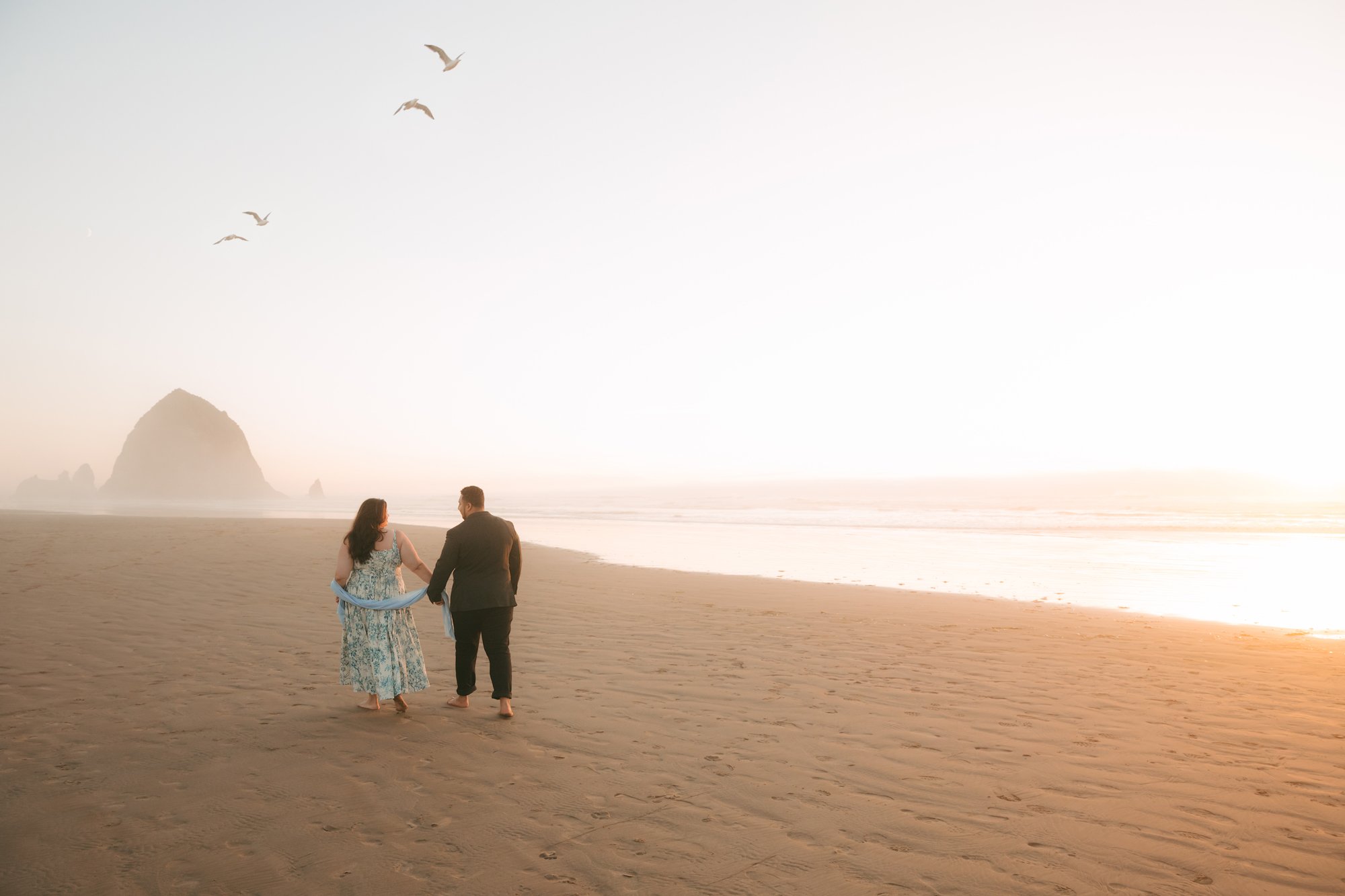 Dreamy Cannon Beach sunset engagement portrait by Eric Doolin, a LGBTQ+ Oregon and destination wedding photographer capturing dreamy, editorial, authentic imagery rich in color and mood.