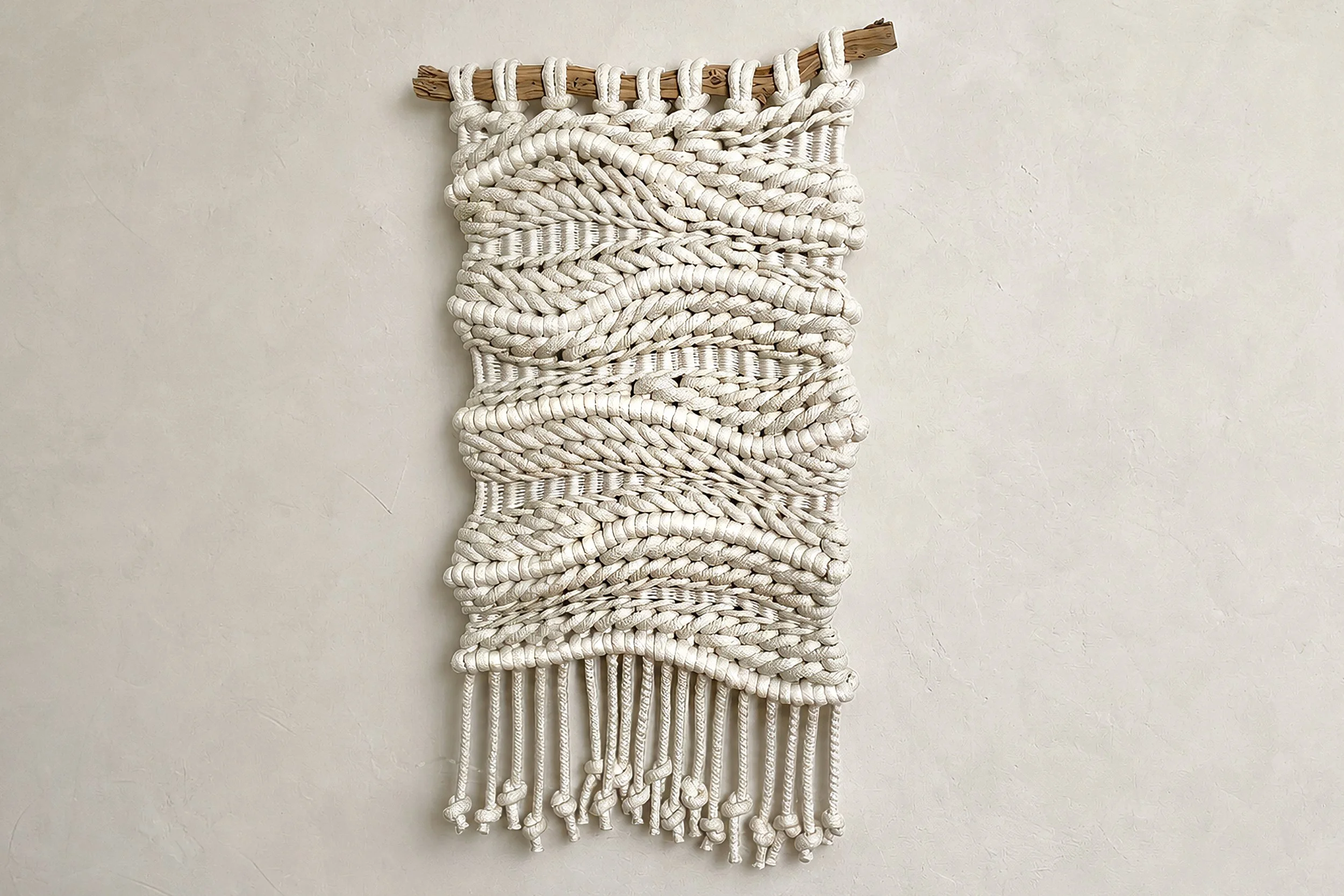Plush Chunky Dimensional Wall Hanging Made From Soft Cozy Natural Cotton Cord On Beige Clay Plaster Wall