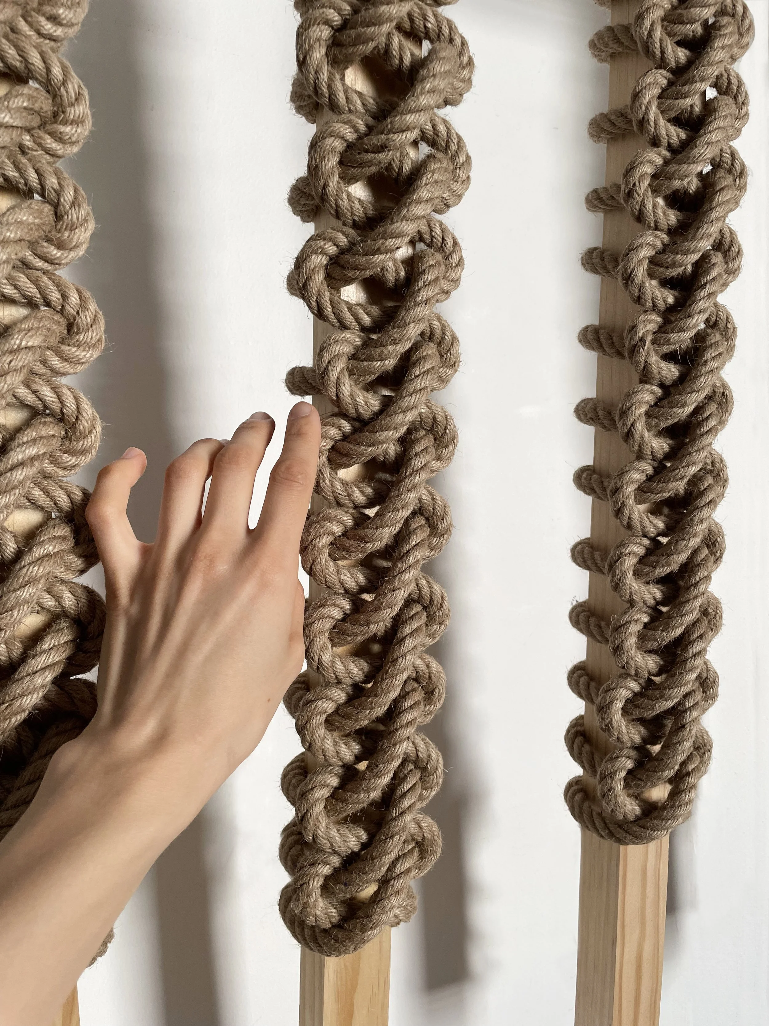 Earth-toned organic jute rope and wood sculptural installation art