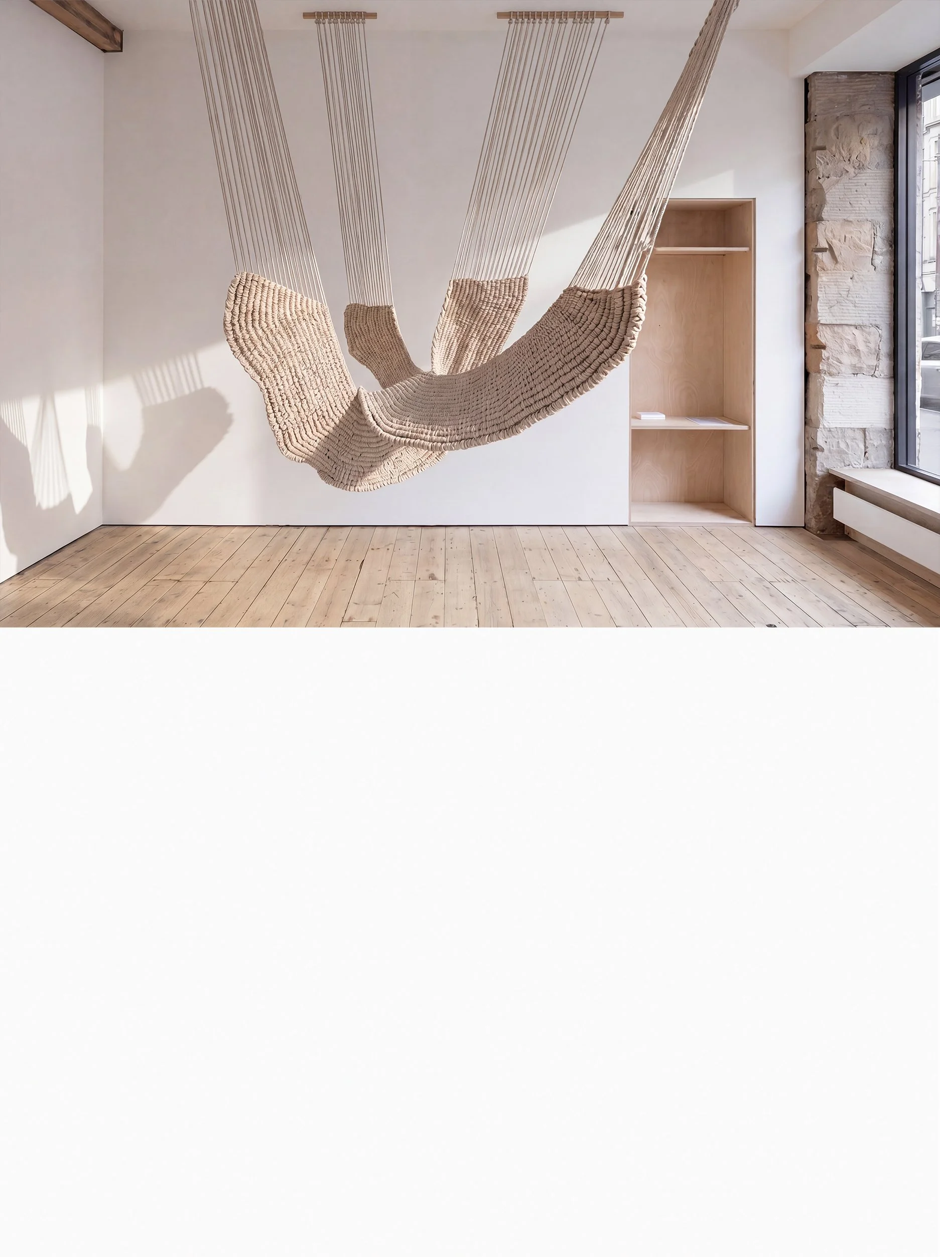 Large natural-white suspended fiber art sculpture in a contemporary gallery space