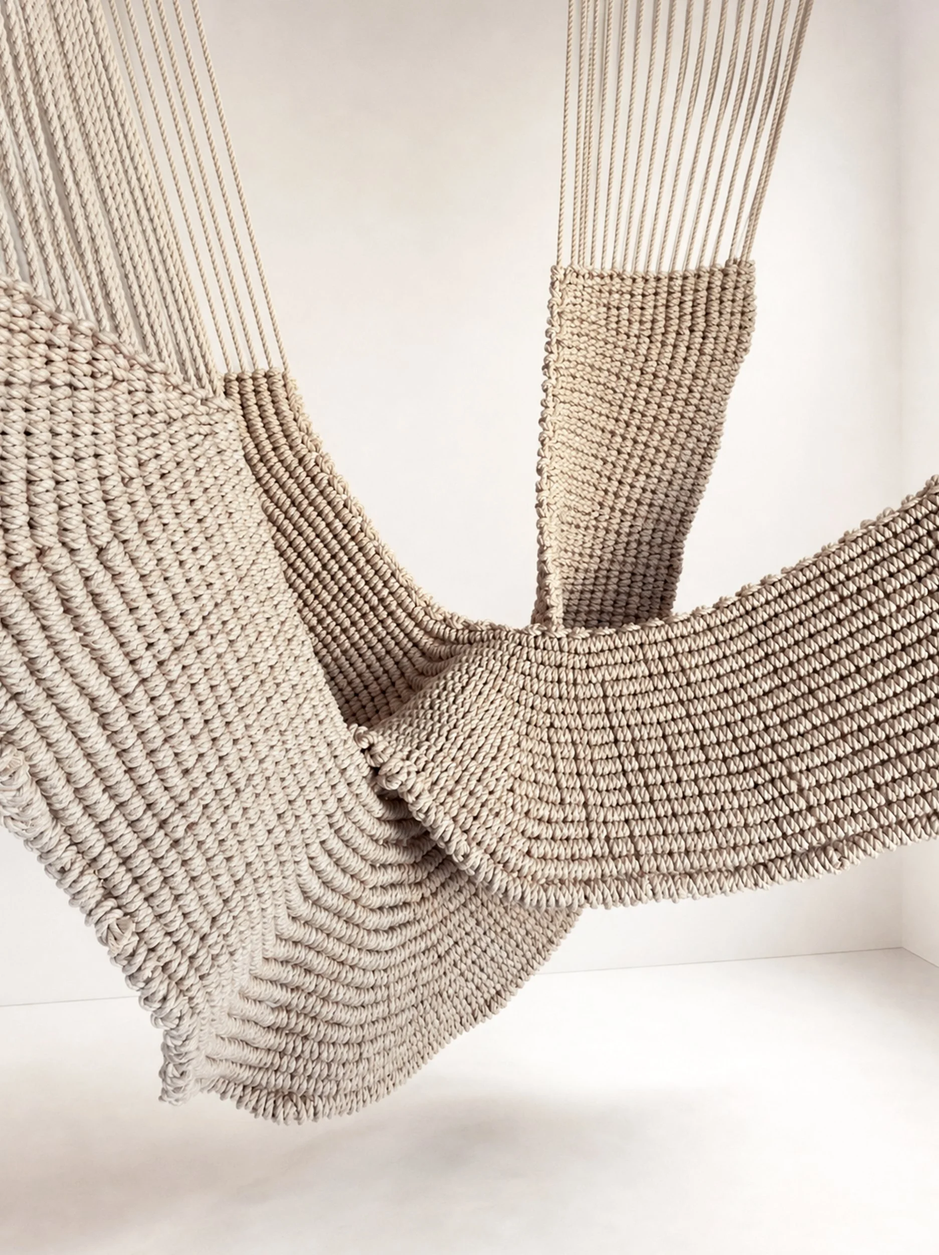 Hanging rope sculpture installation made from thick natural white cotton rope