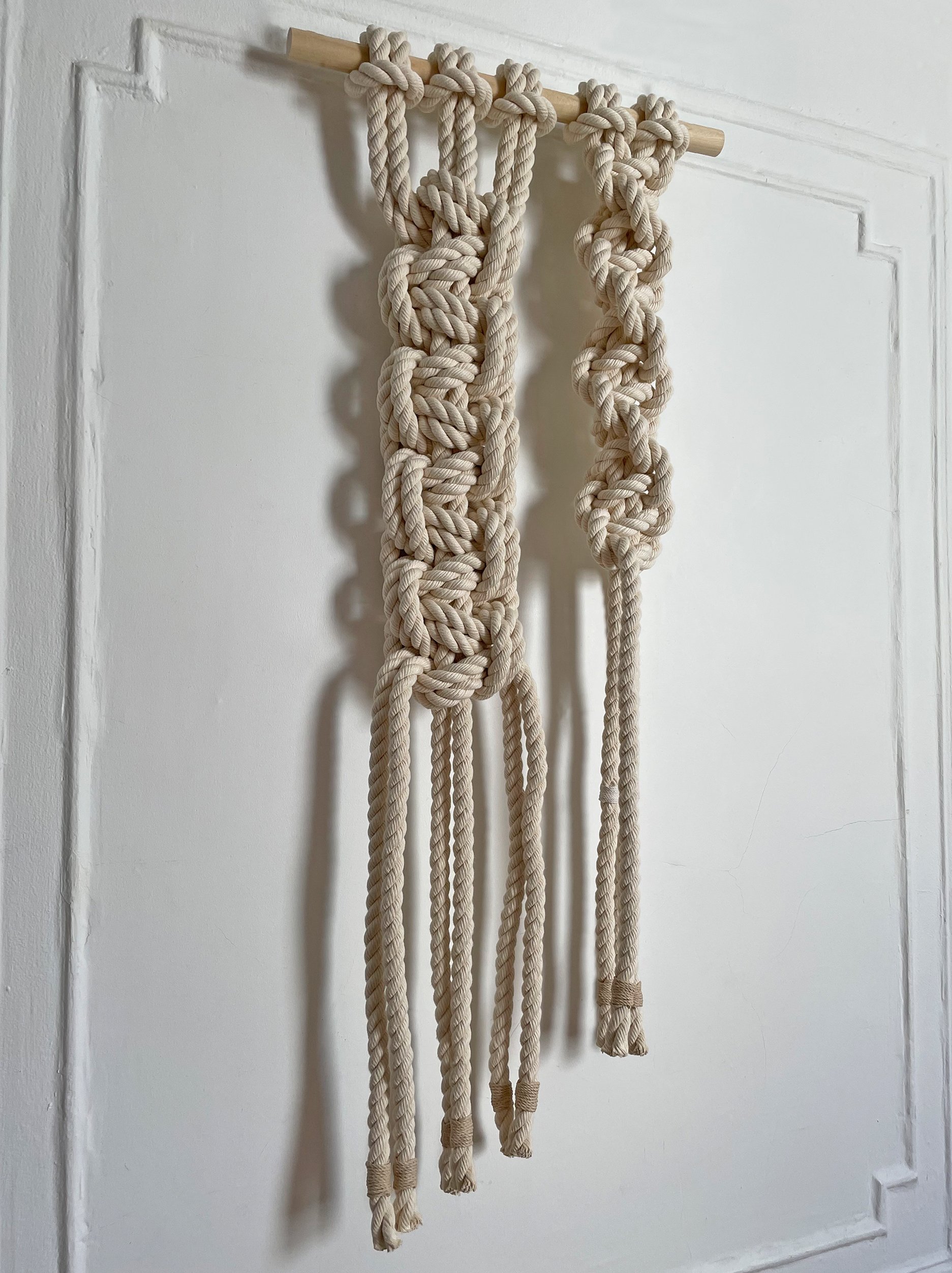 Large twisted rope knot art and XL macrame wall hanging displaying the natural poplar wood rod support and architectural scale of the textile sculpture
