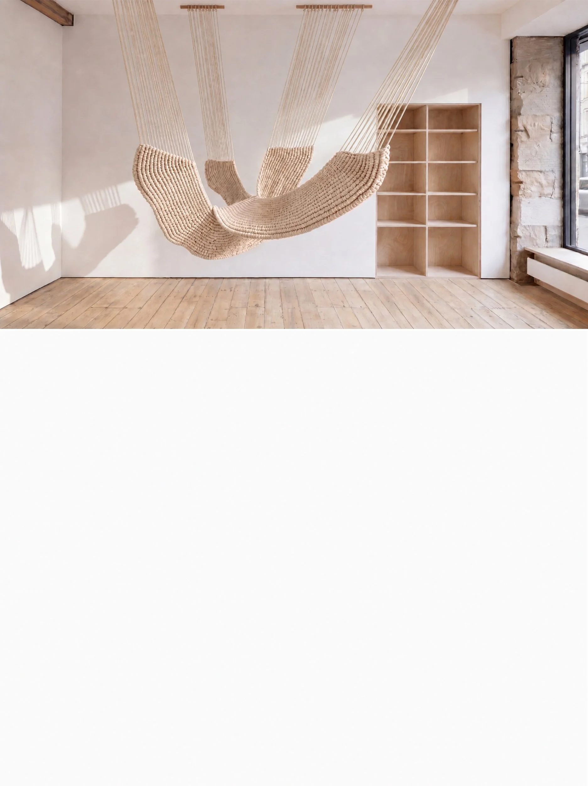 Large natural-white suspended fiber art sculpture in a contemporary gallery space