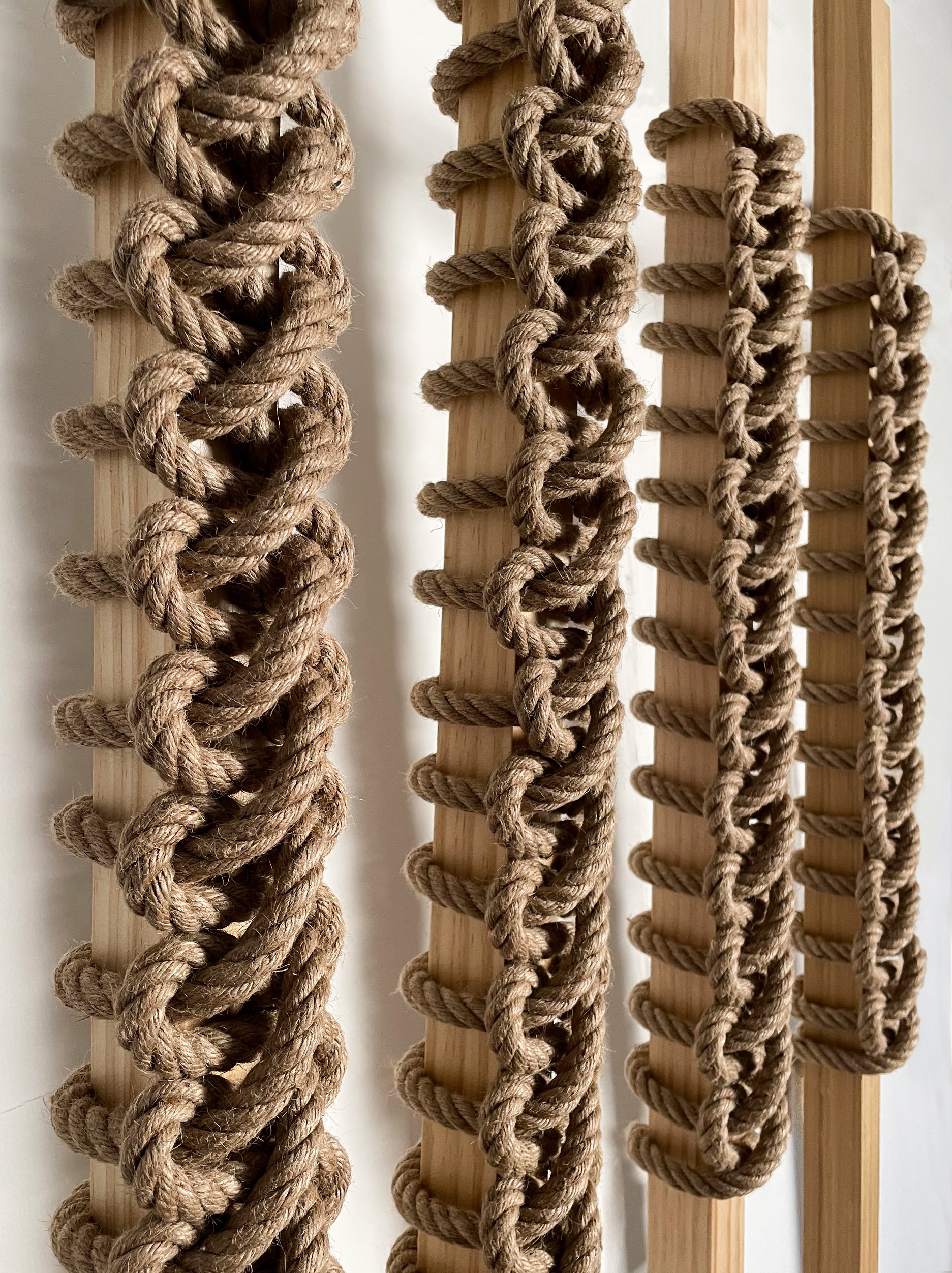 Textural architectural installation  with repeating knotted motifs  and high-relief surface