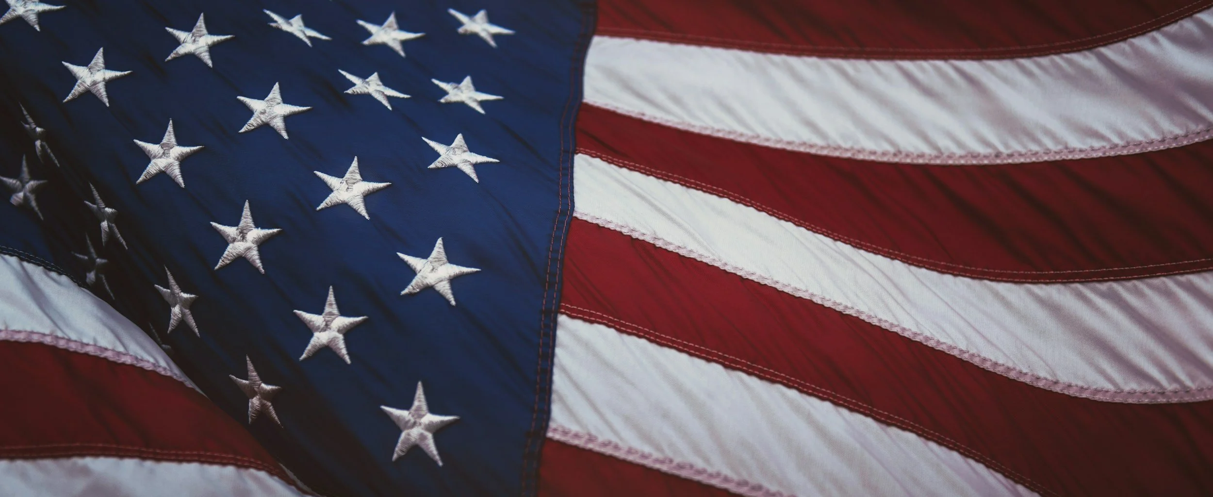 Close-up of the American flag with stars and stripes.