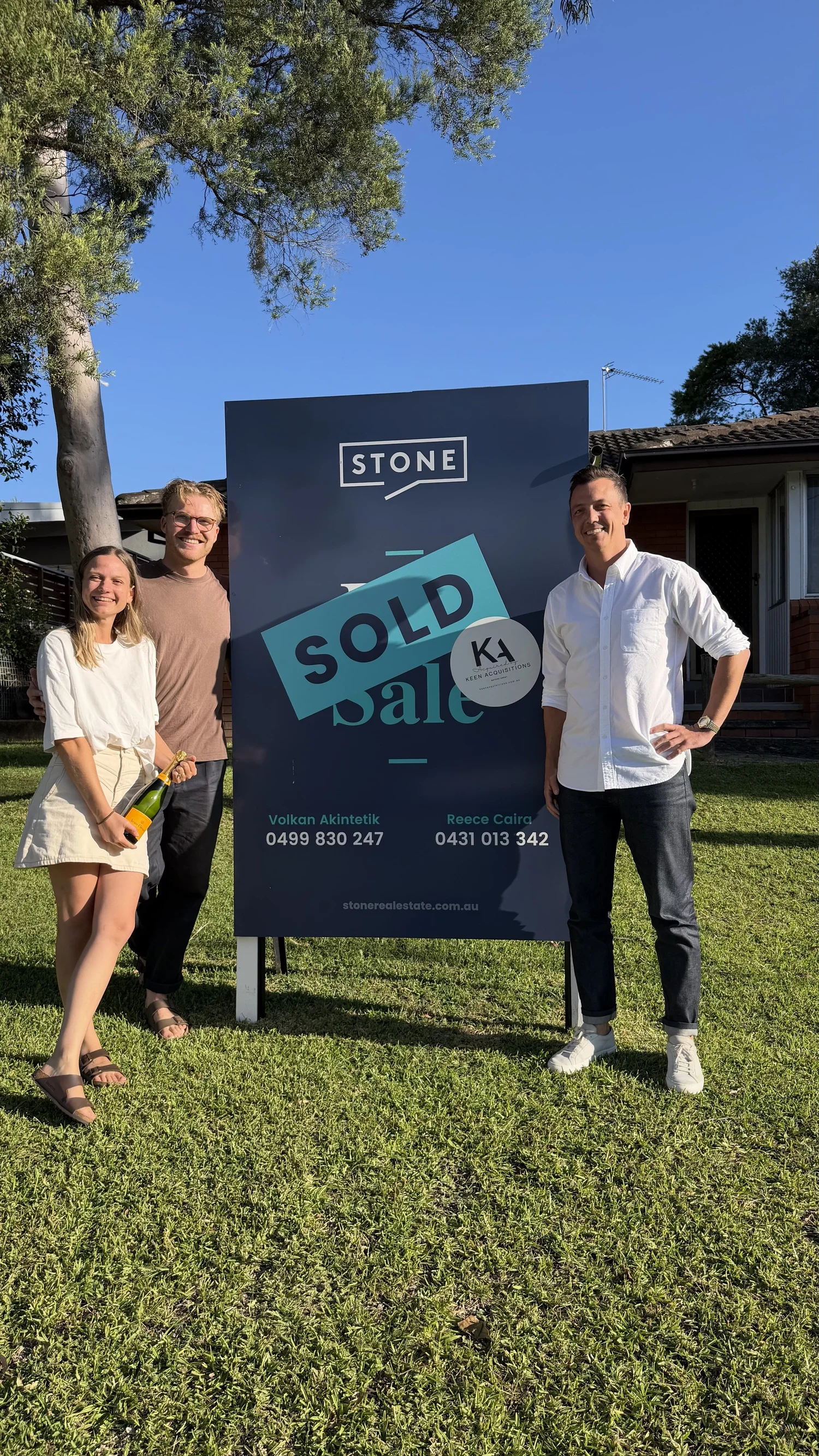 Mitch Keen with a family of buyers on the Central Coast