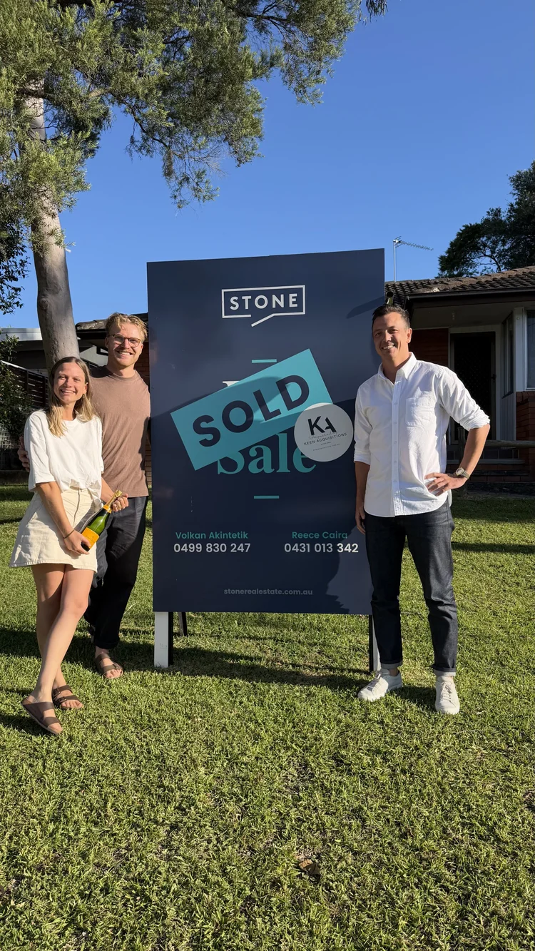 Mitch Keen with a family of buyers on the Central Coast