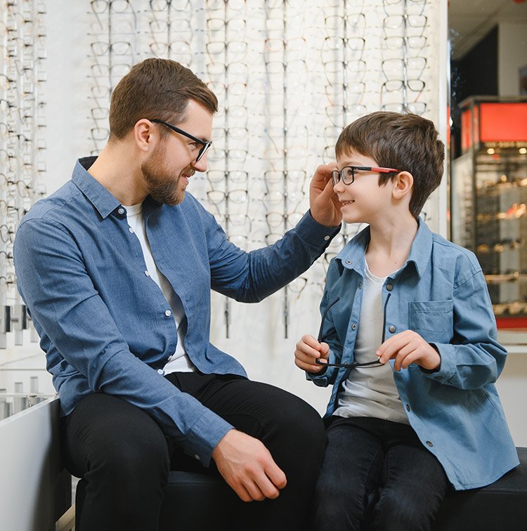 A dad and son at the eye doctor office