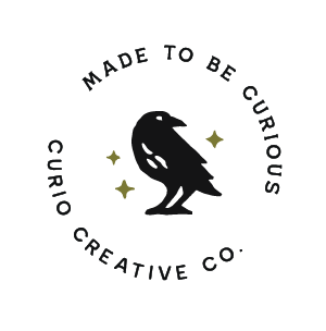 A black crow illustration surrounded by the text 'Made to Be Curious' and 'Curio Creative Co.' with star accents.