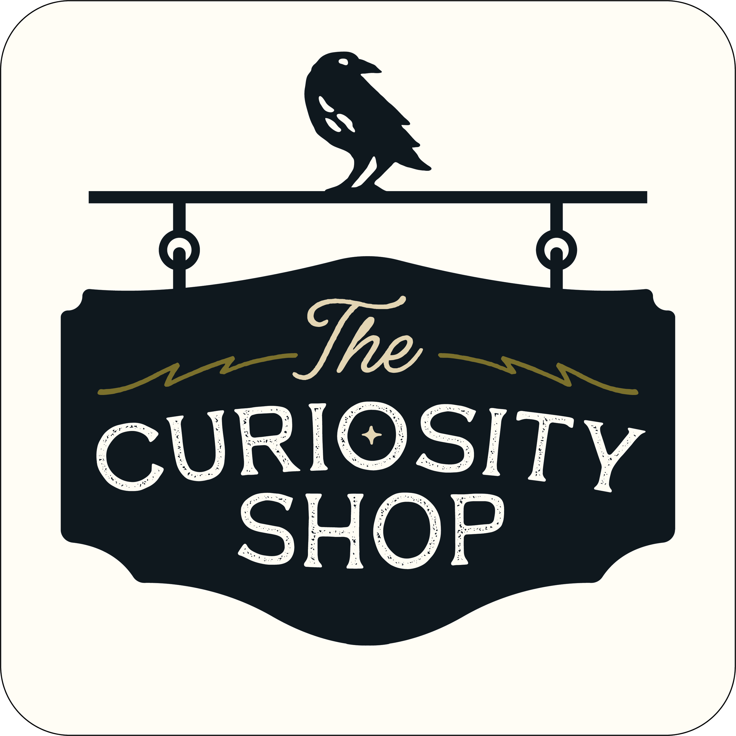 Black and cream-colored sign reading 'The Curiosity Shop' with a small bird graphic on top.