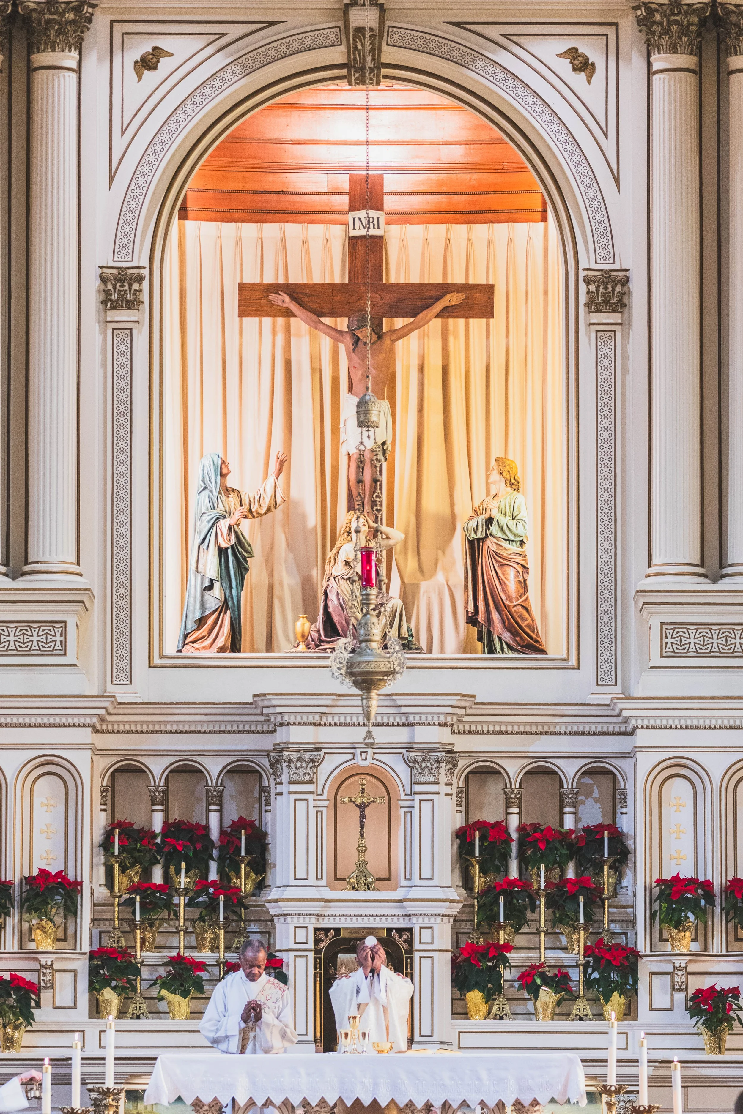 A  Catholic priest elevates the consecrated host at a Holy Mass at Immaculate Conception Parish in Seattle, WA