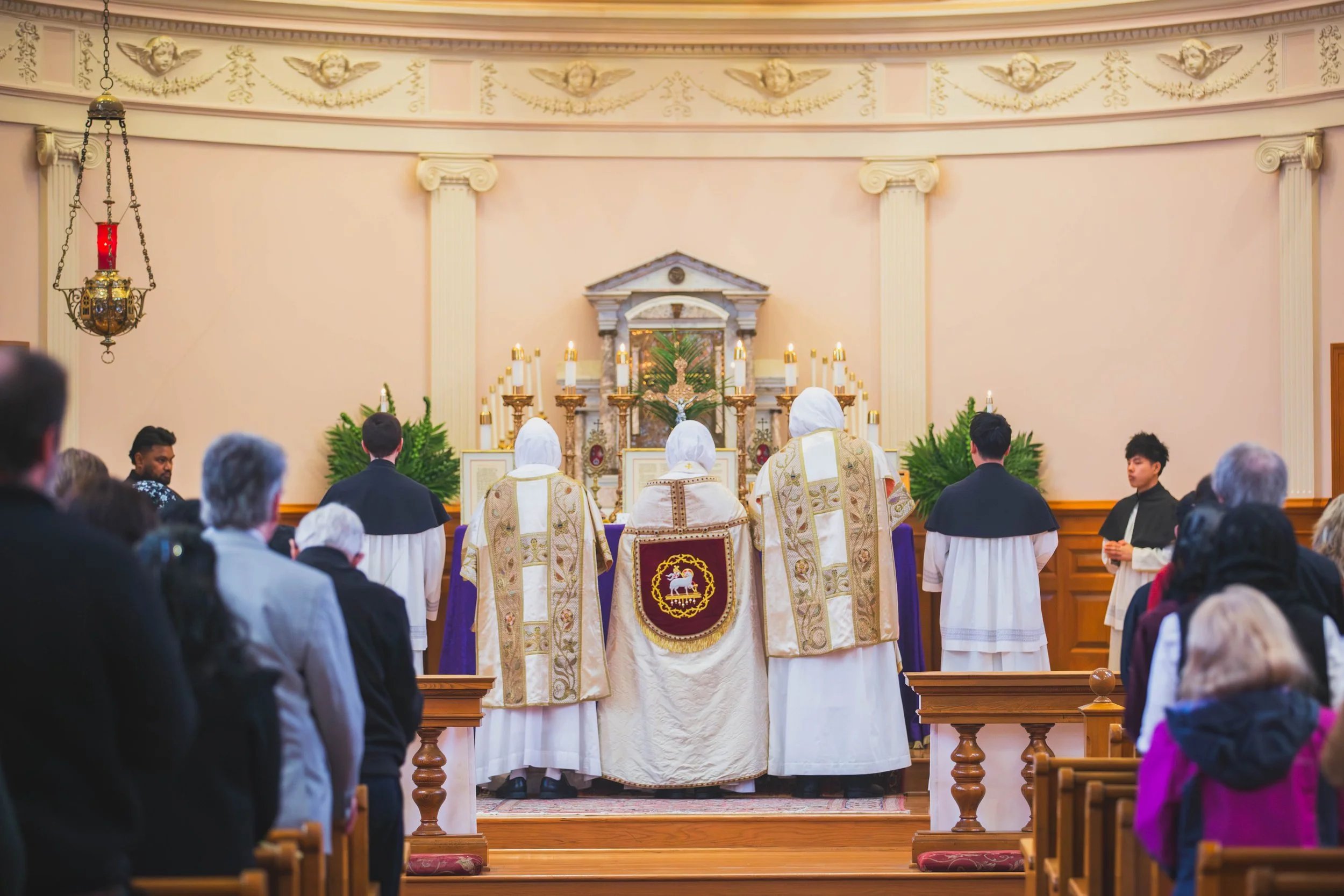 A Dominican rite Solemn High Mass during Palm Sunday with a priest, deacon and subdeacon in Holy Rosary Parish in Portland, OR.