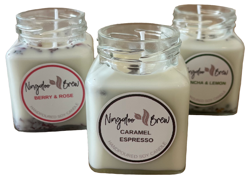 Three scented soy candles in glass jars with labels that read 'Naraglo Brew' and their respective scents: Caramel Espresso, Berry & Rose, and Matcha & Lemon.