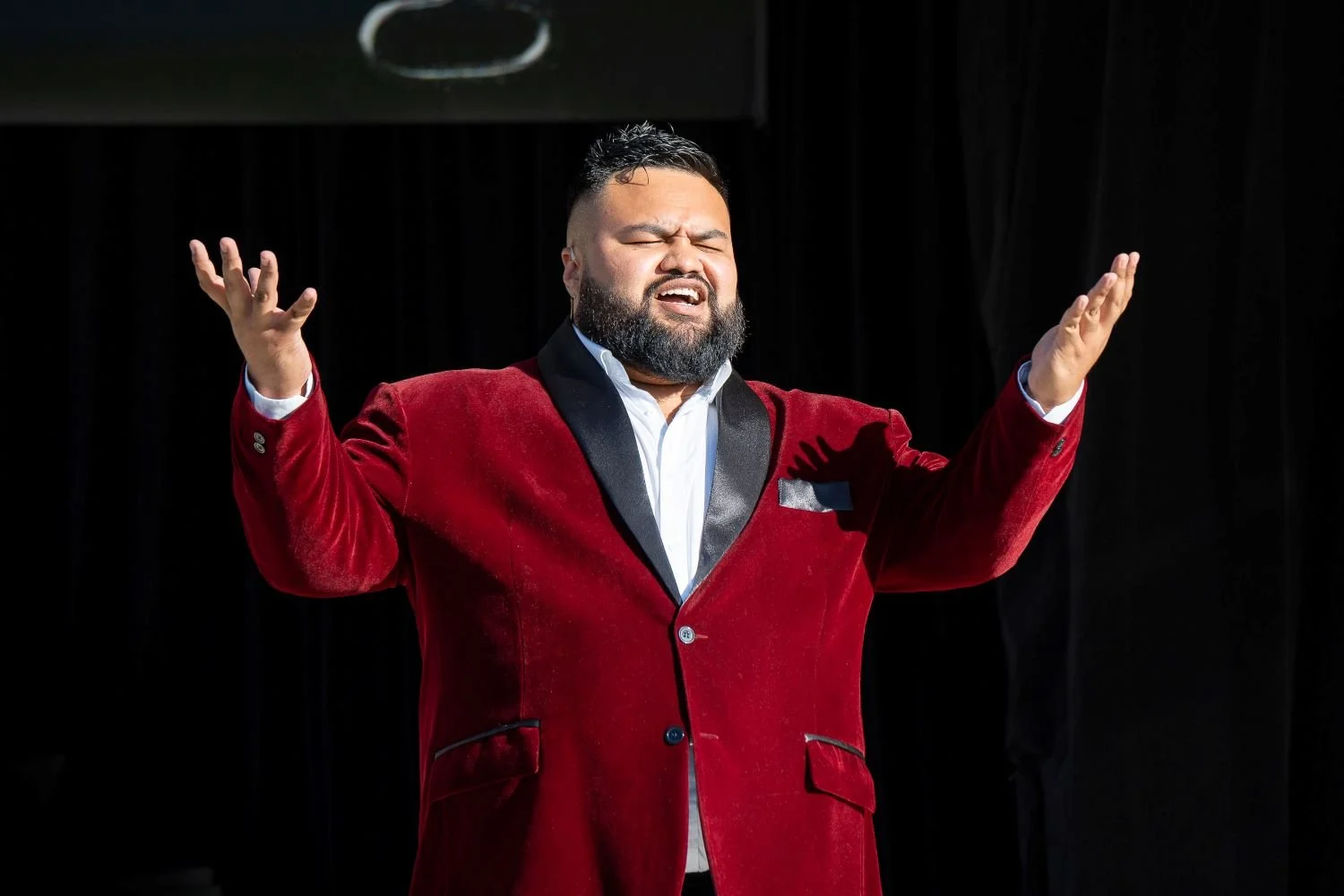 Frame-Power-Photography-Man-in-red-velvet-jacket-singing-with-eyes-closed.jpg