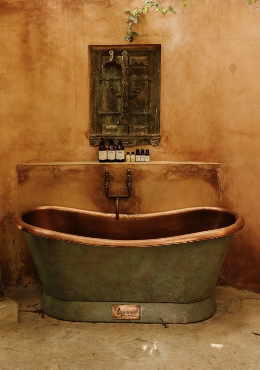 Interior design of an outdoors bathroom with copper bathtub in Asia, by Howark Design