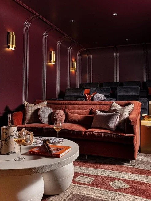 Cinema space by Marie Cloud with deep burgundy walls and ceilings