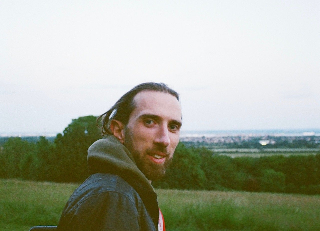 Stefan is a white man brown slick back hair and a beard.