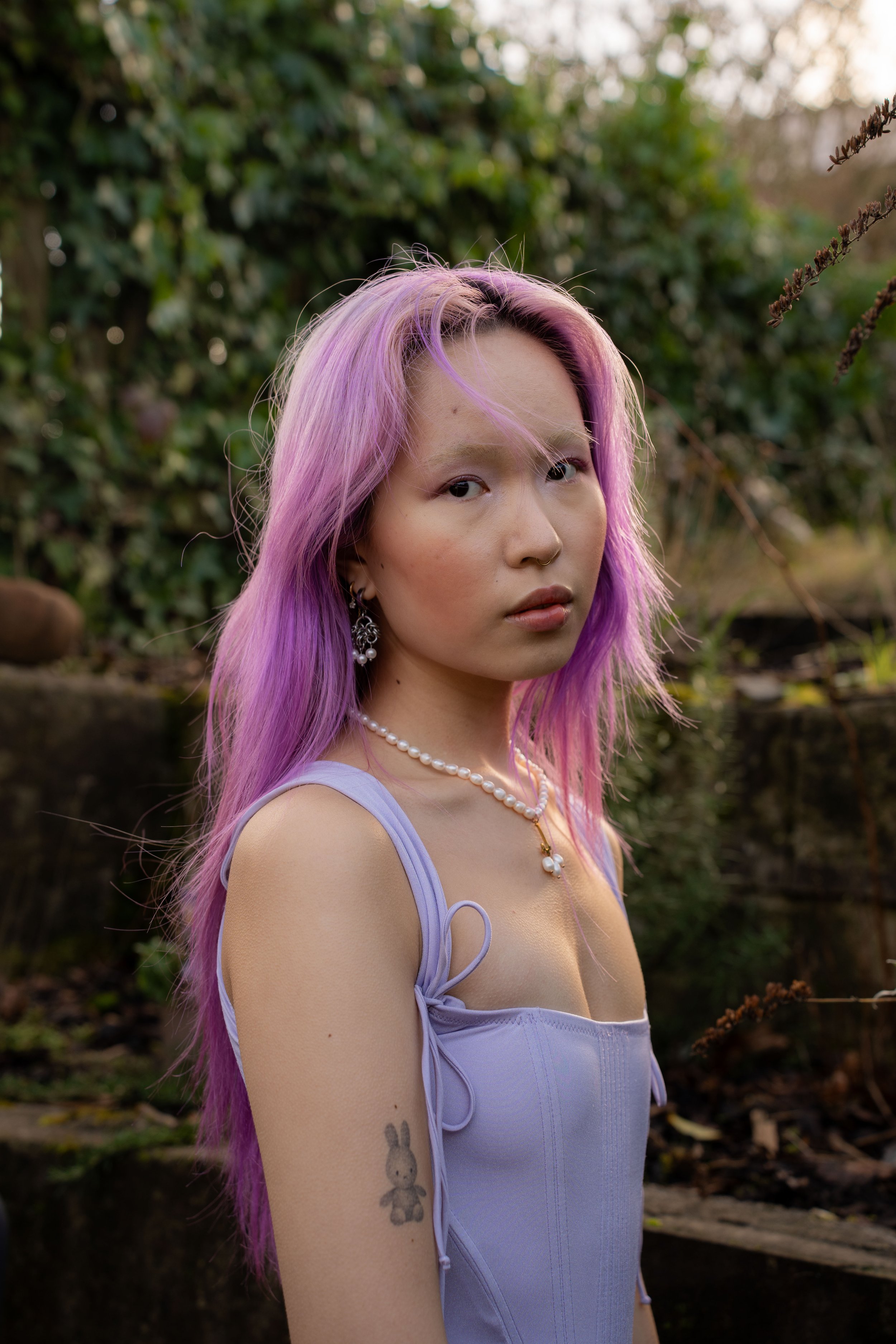 Portrait of Josie Tang with purple hair