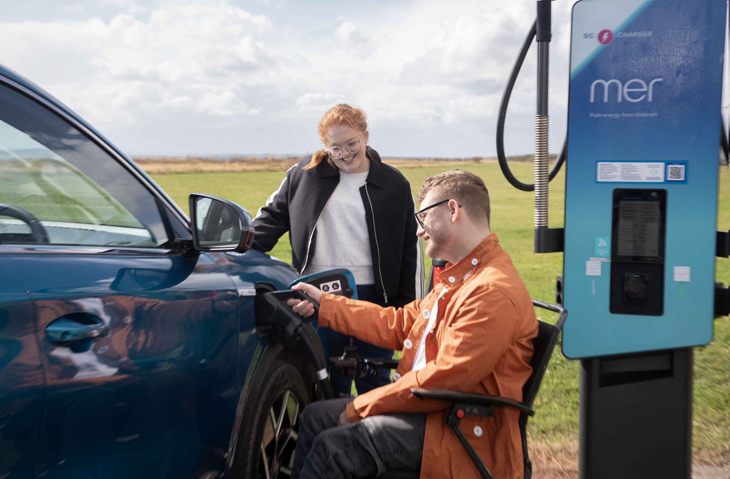 Campaign image of Alex MacKenzie - charging EV