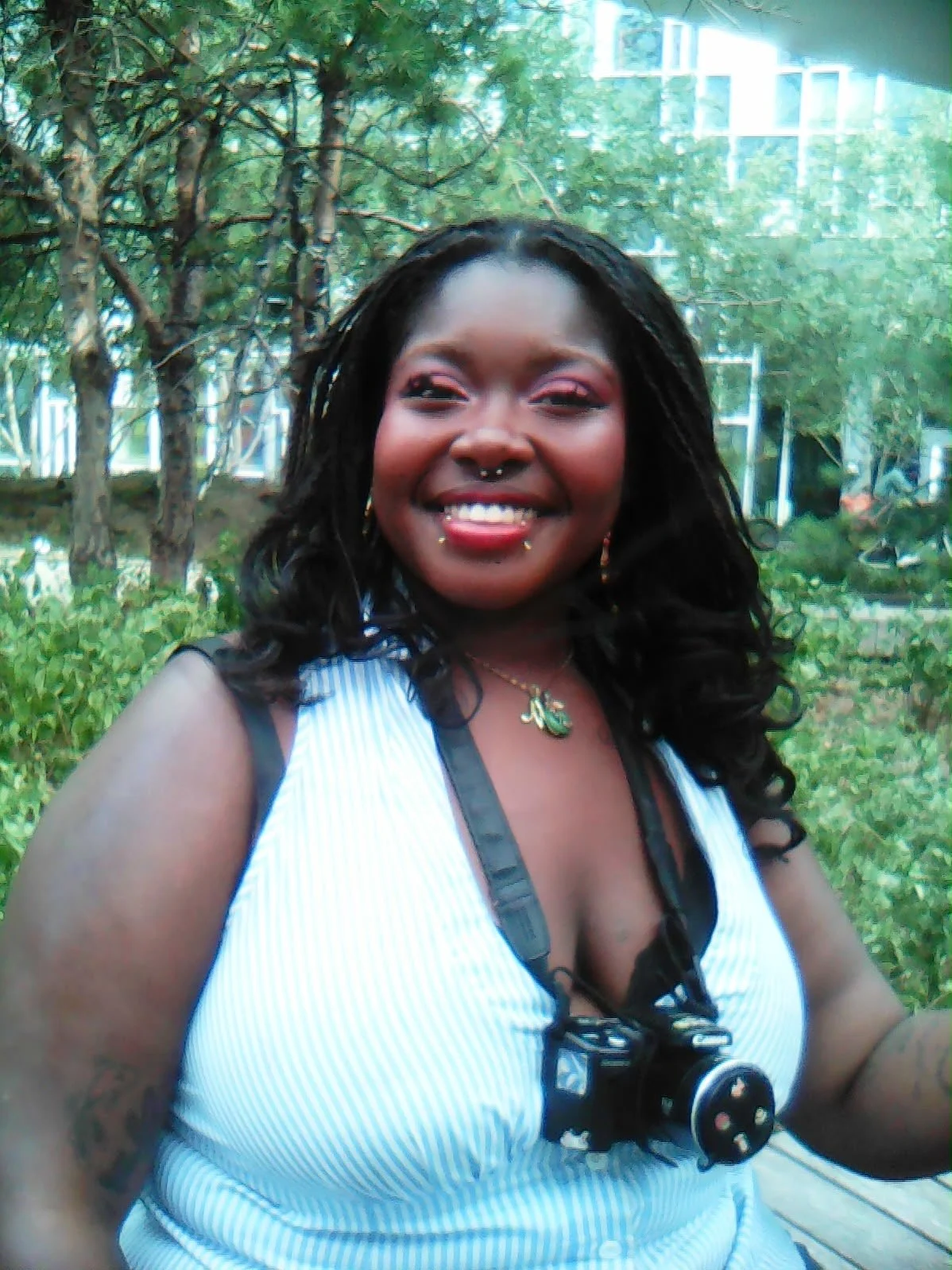 Portrait of Ola Oguntuase with camera