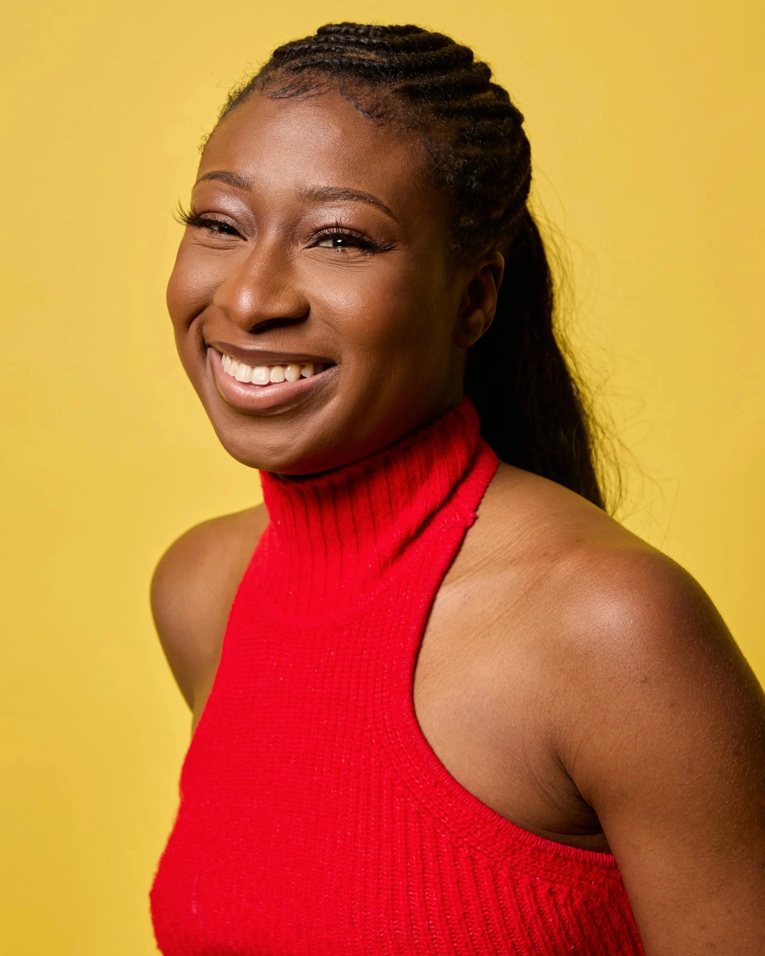 Portrait of Katouche Golls smiling - yellow background