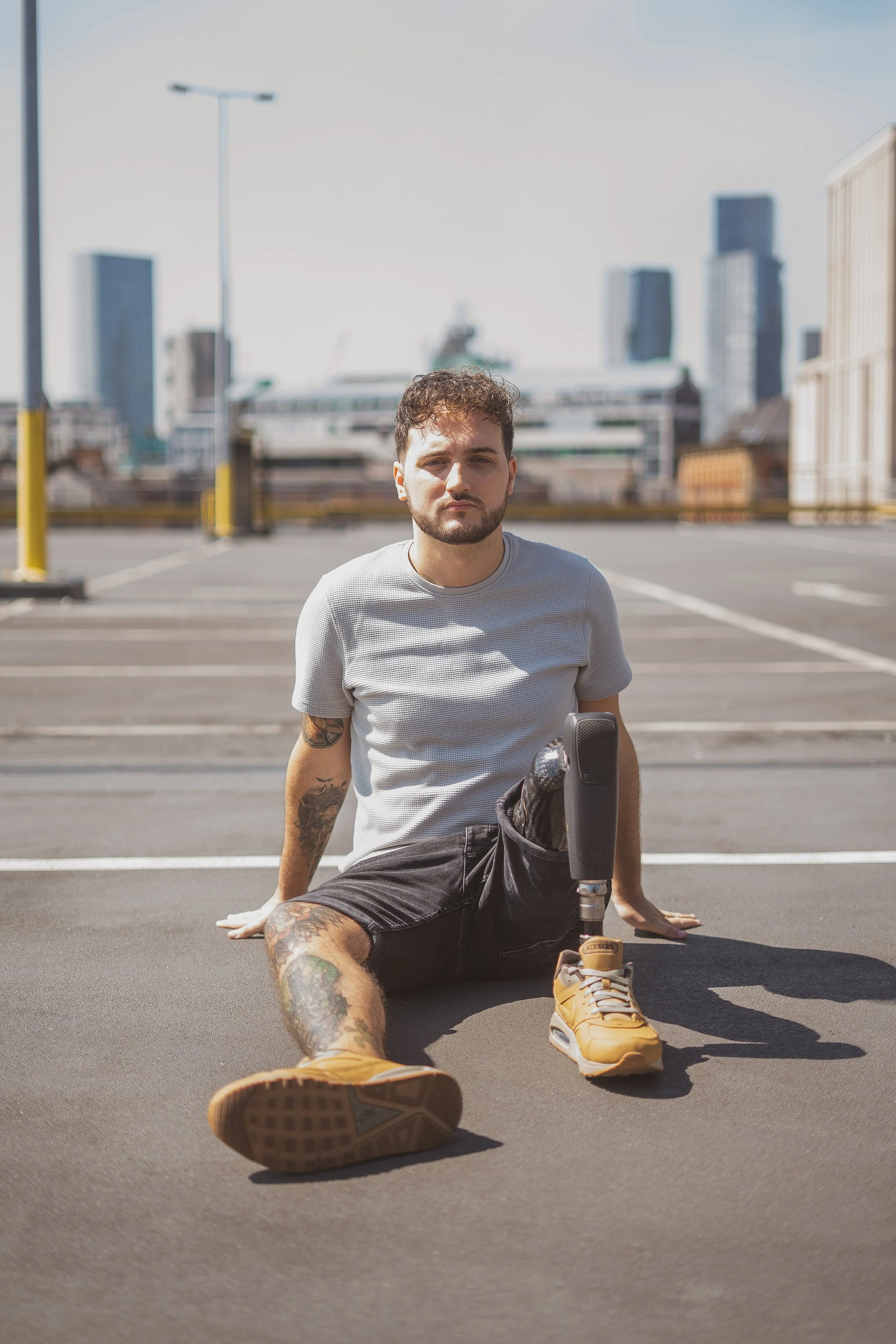 Portrait of Aniello Davies sat on pavement