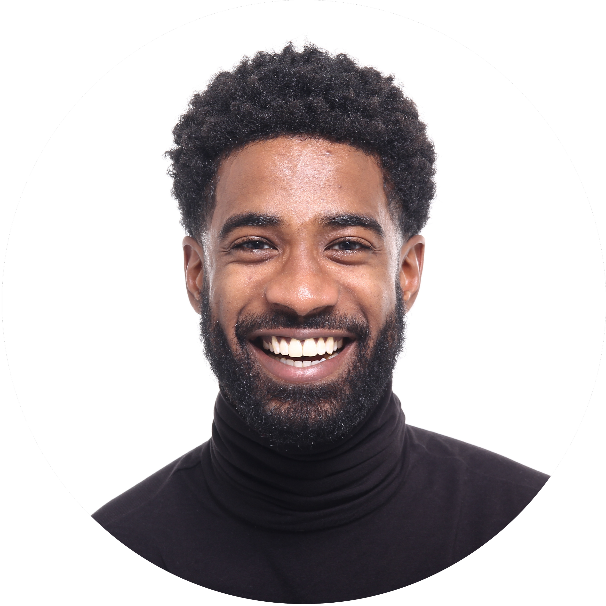 A man with a beard and curly hair smiling broadly, wearing a black turtleneck against a white background.